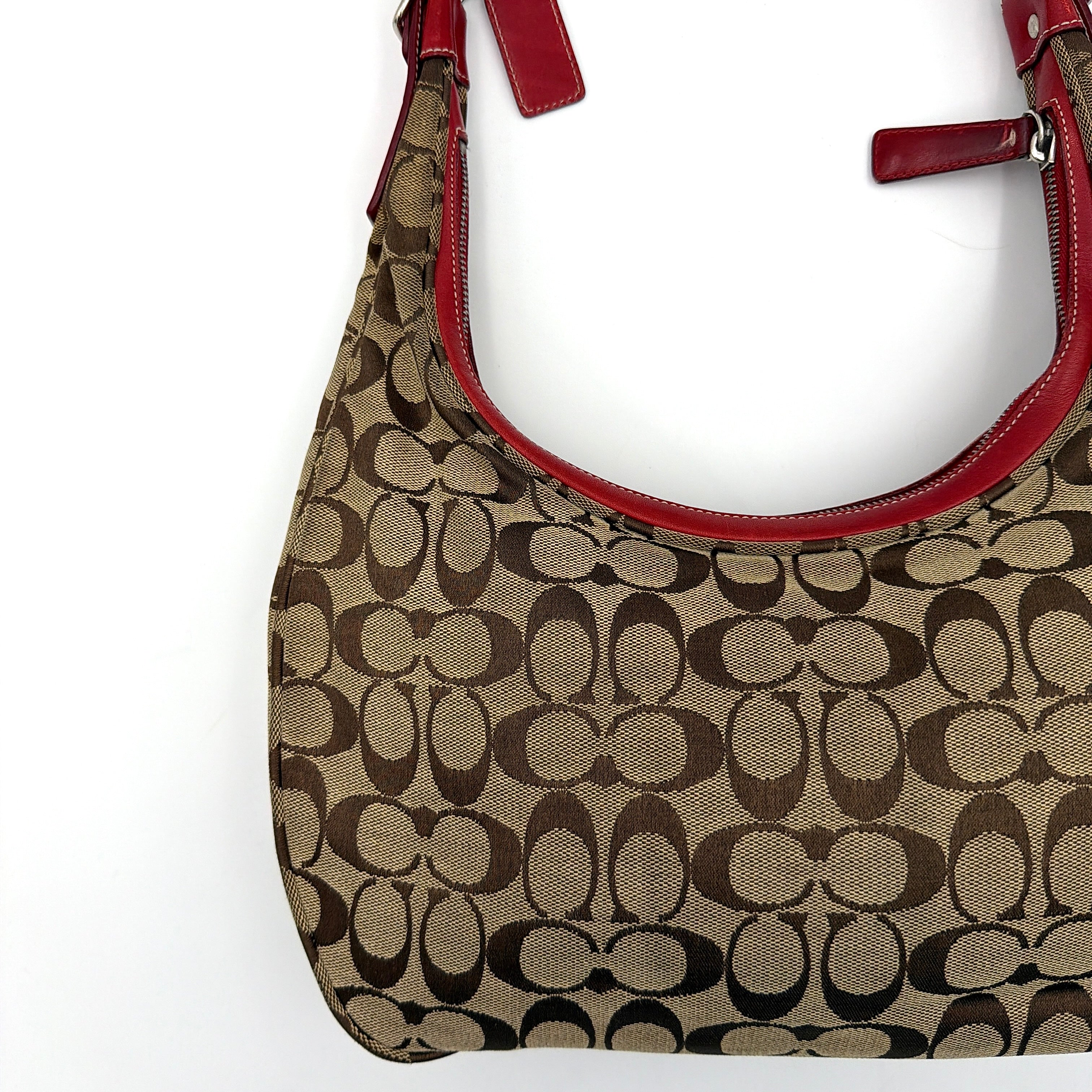 Coach Signature Hamilton Hobo Shoulder Bag in beige monogram canvas with striking red leather trim and a wide hobo silhouette.