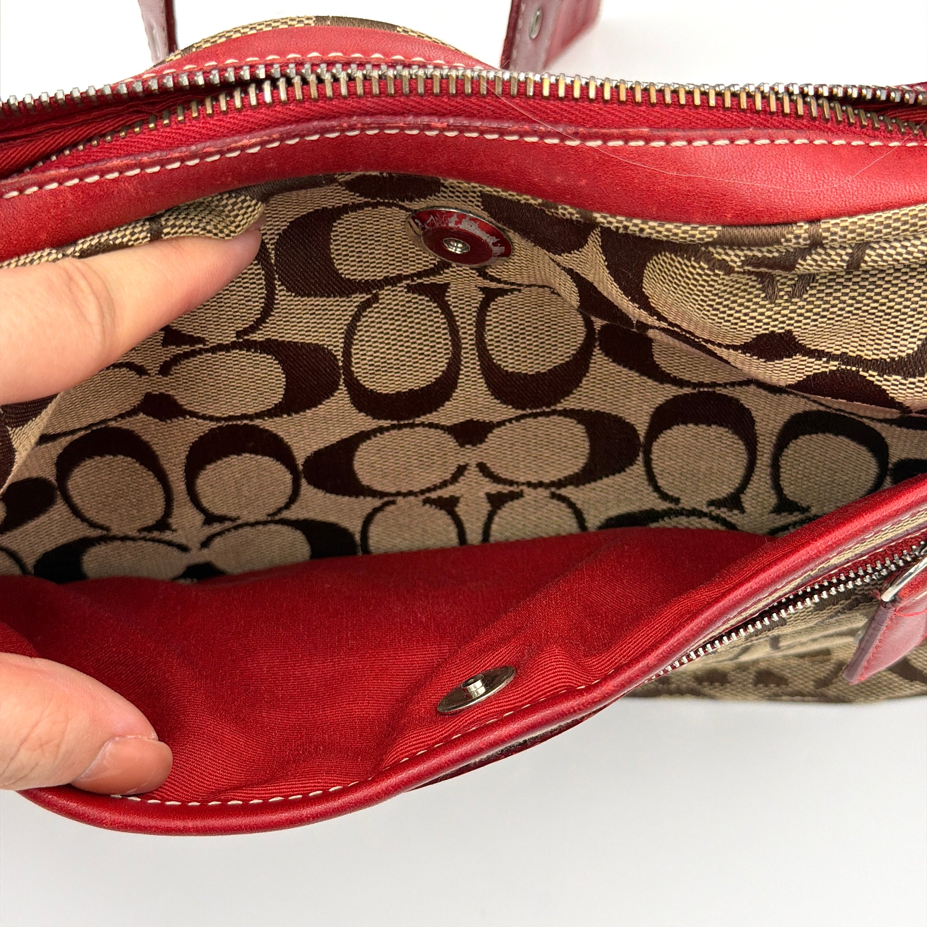 Coach Signature Hamilton Hobo Shoulder Bag in beige monogram canvas with striking red leather trim and a wide hobo silhouette.
