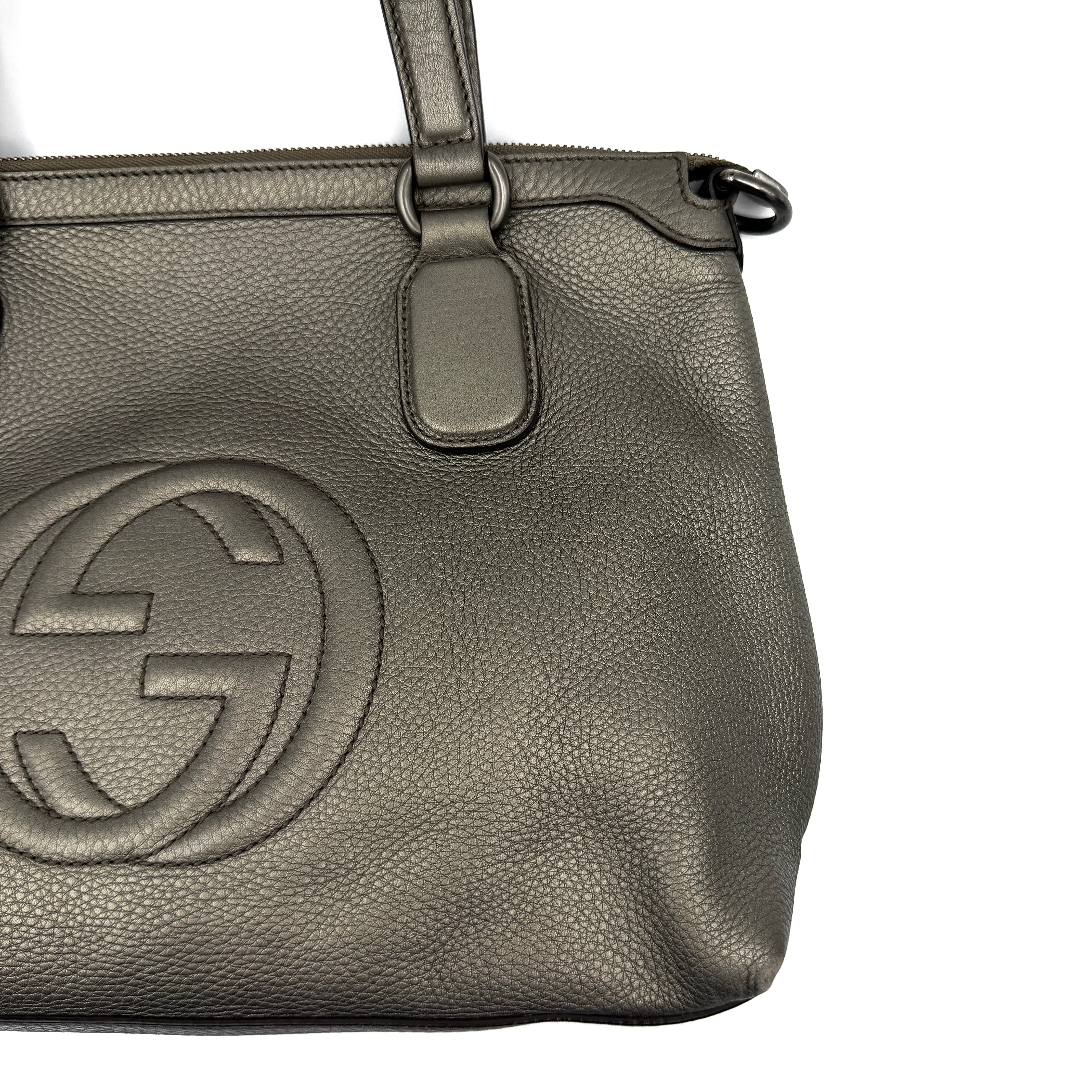 Gucci GG Soho Shoulder Bag in grey pebbled leather, featuring dual top handles, oversized stitched GG logo, and a leather tassel zip pull.