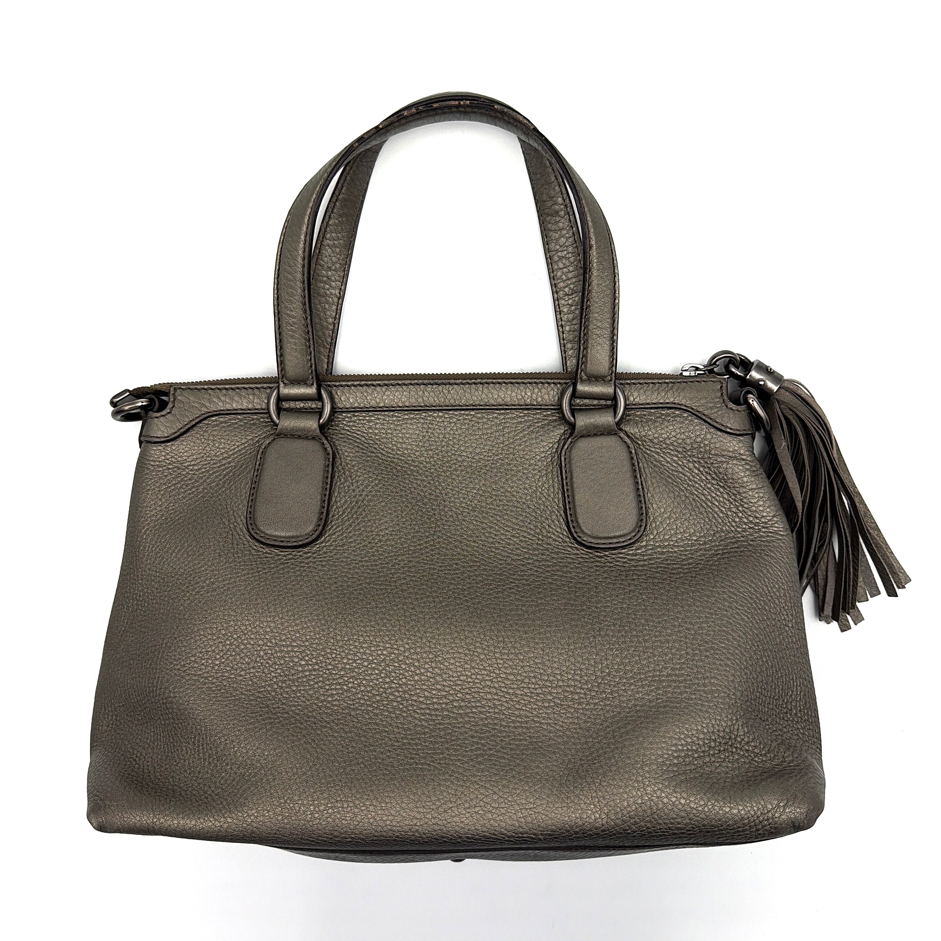 Gucci GG Soho Shoulder Bag in grey pebbled leather, featuring dual top handles, oversized stitched GG logo, and a leather tassel zip pull.