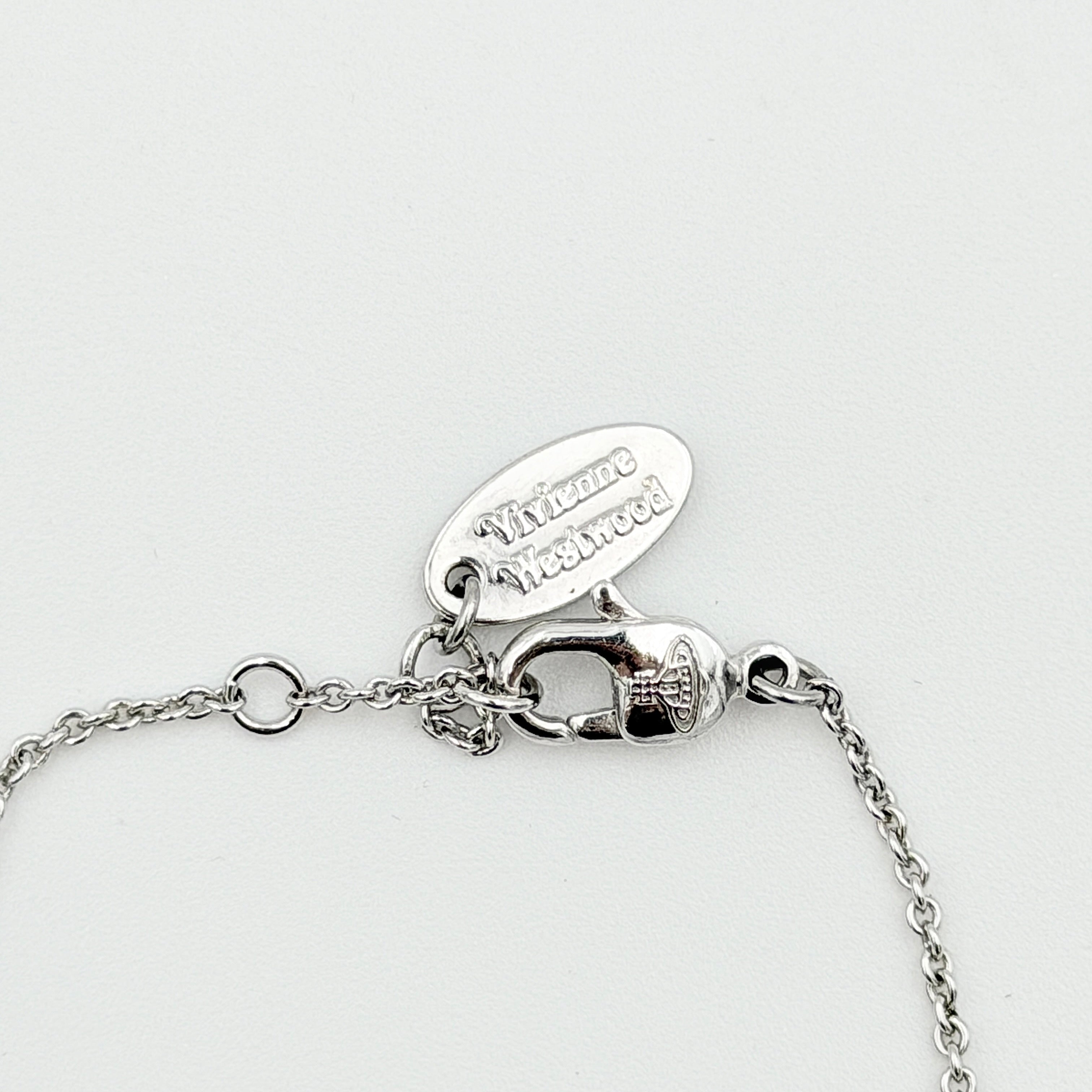 Vivienne Westwood silver rhinestone Orb bracelet with delicate chain and branded tag, shown against a clean background.