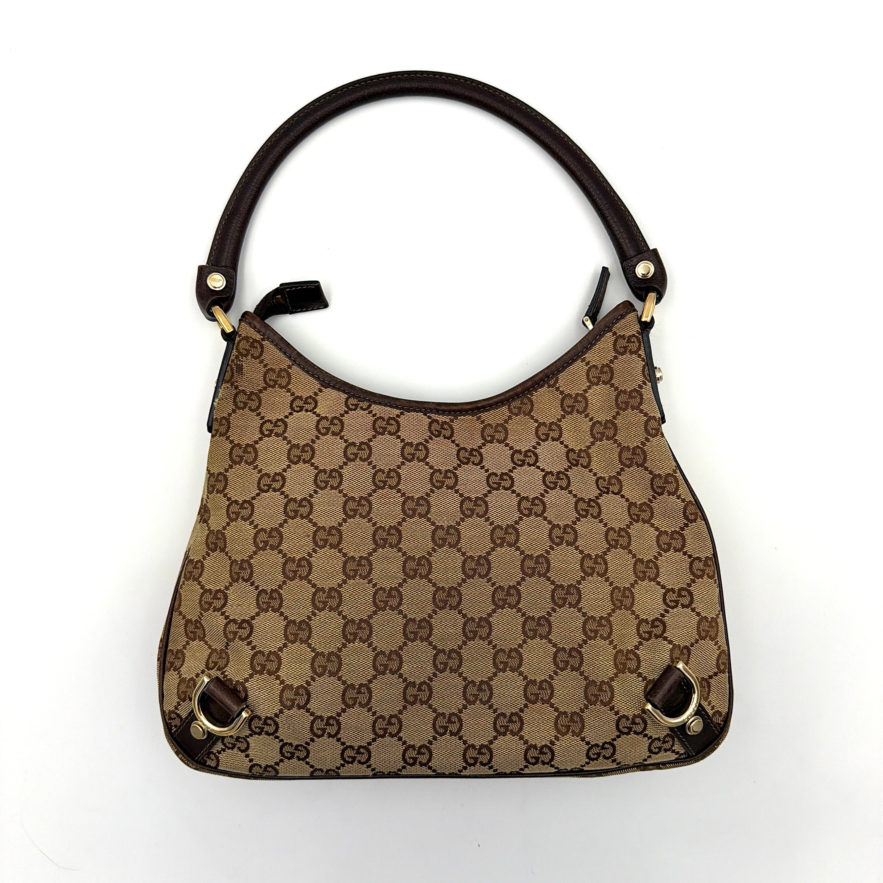 Front view of the Gucci GG Monogram Jacquard Abbey Hobo Bag in beige and brown canvas with gold-tone hardware and dark brown leather trim.