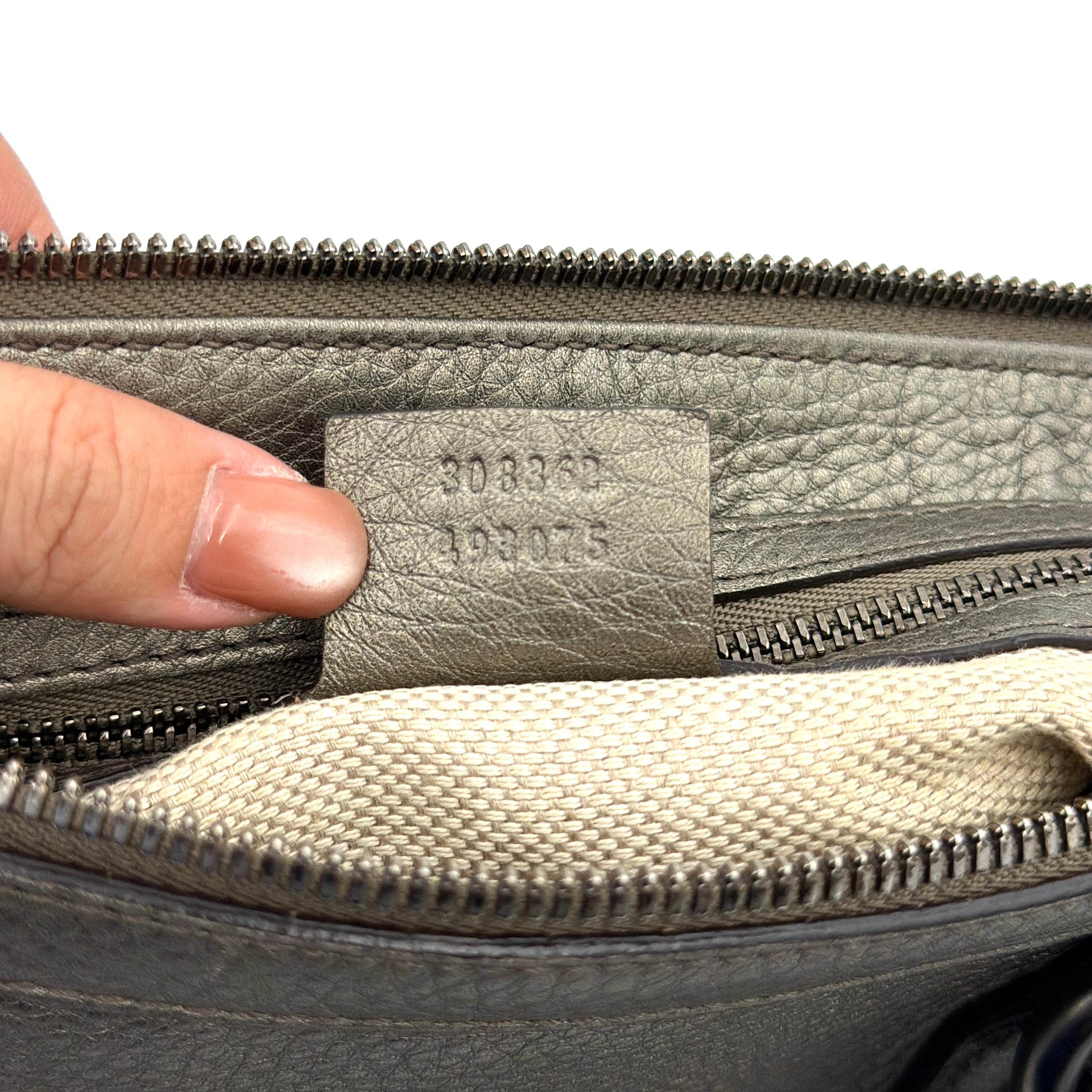 Gucci GG Soho Shoulder Bag in grey pebbled leather, featuring dual top handles, oversized stitched GG logo, and a leather tassel zip pull.