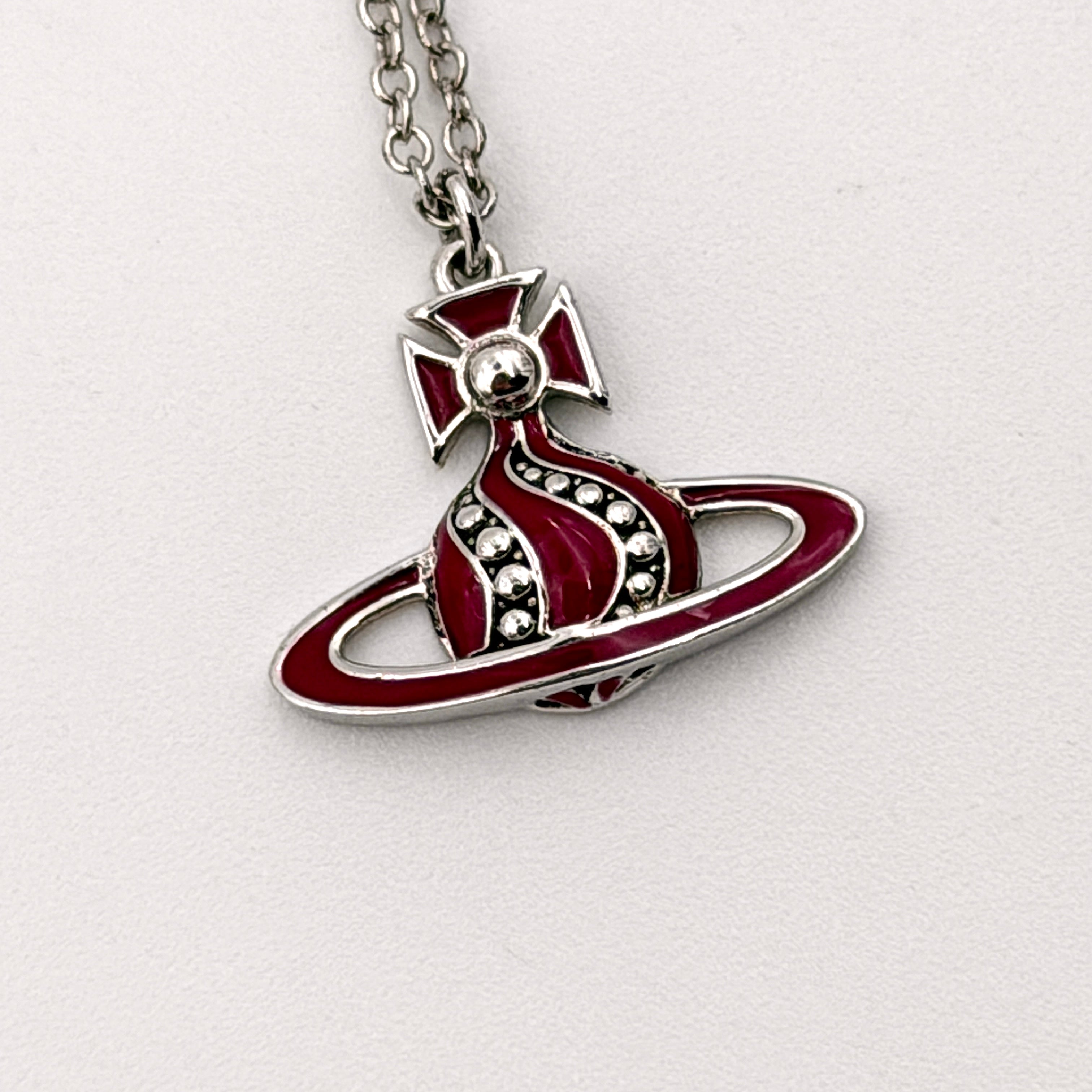 Vivienne Westwood Orb Enamel Necklace in burgundy and silver, featuring the signature orb pendant on a fine chain.