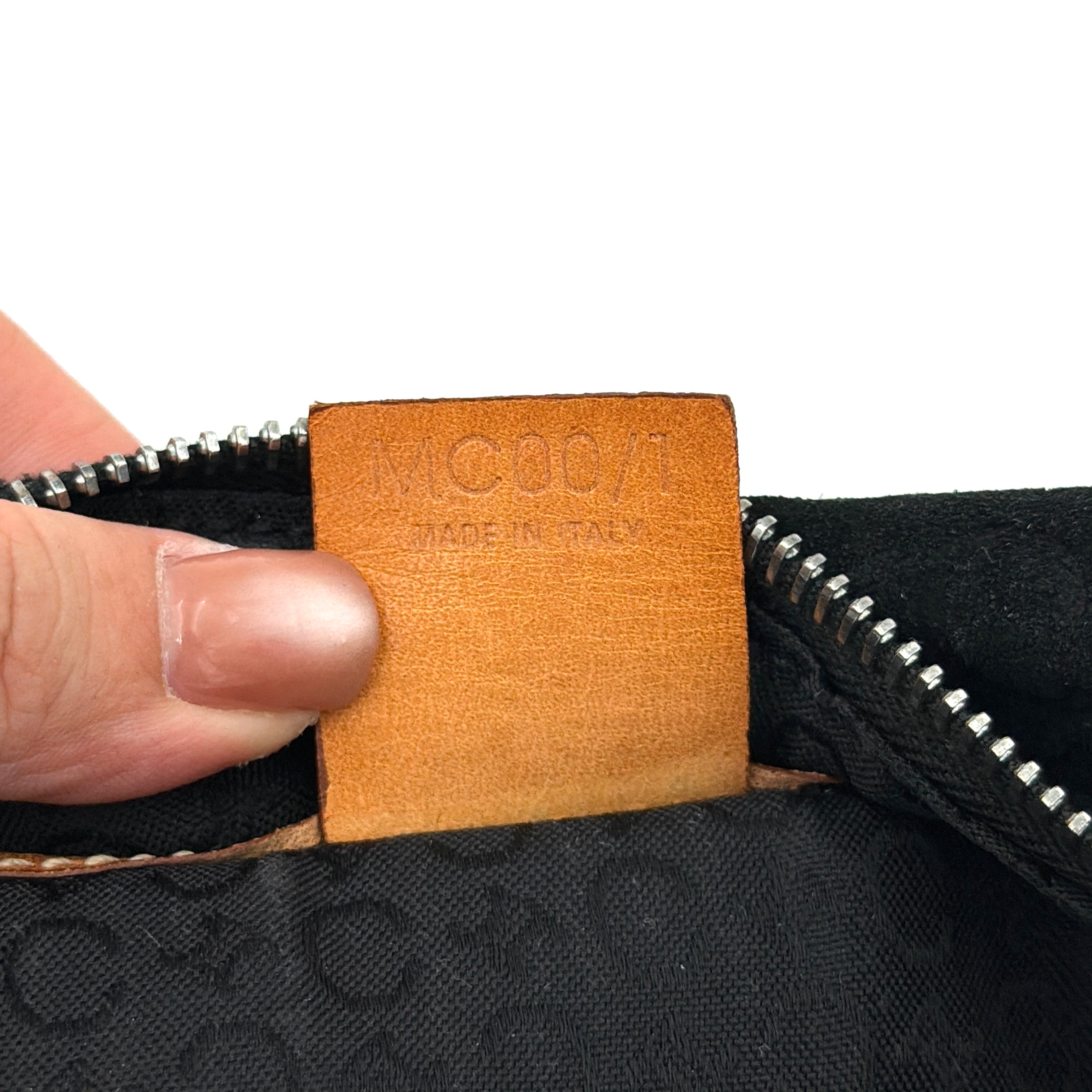 Celine black suede shoulder bag with embossed Triomphe motif, tan leather strap and silver-tone hardware, displayed from the front.