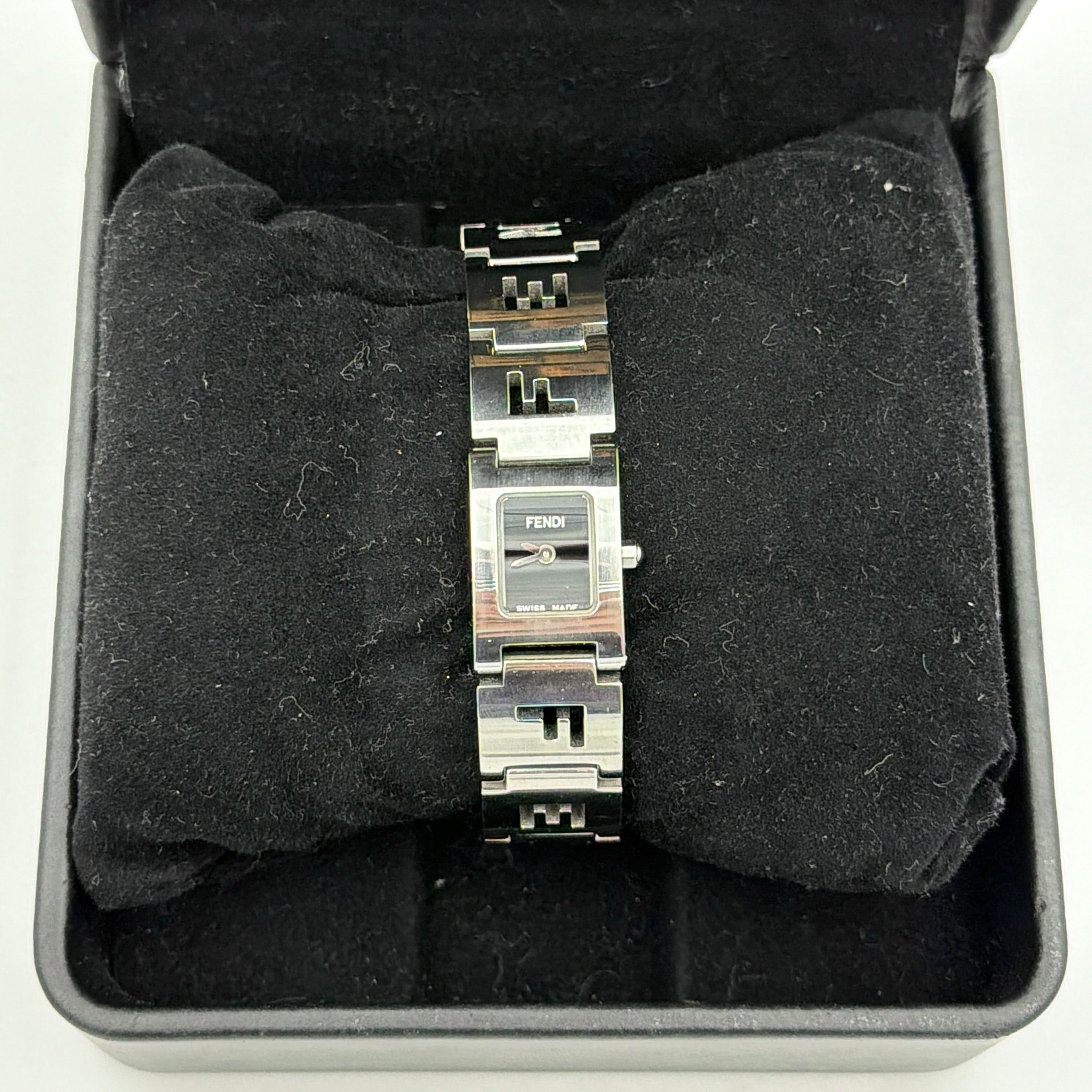 Fendi 3150L FF Logo Belt Watch in silver with a black dial, presented in a black Fendi box with gold logo accents.