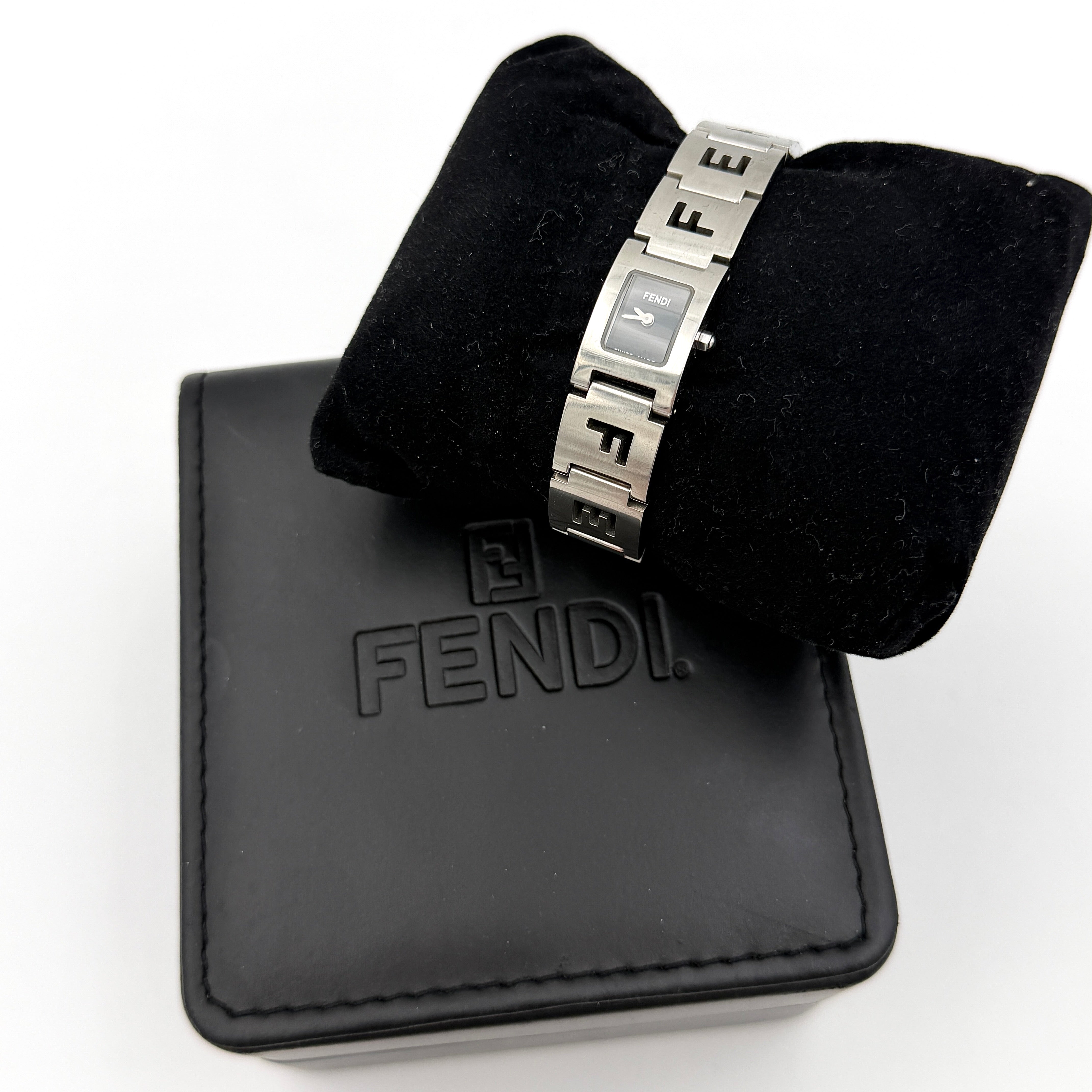 Fendi 3150L FF Logo Belt Watch in silver with a black dial, presented in a black Fendi box with gold logo accents.
