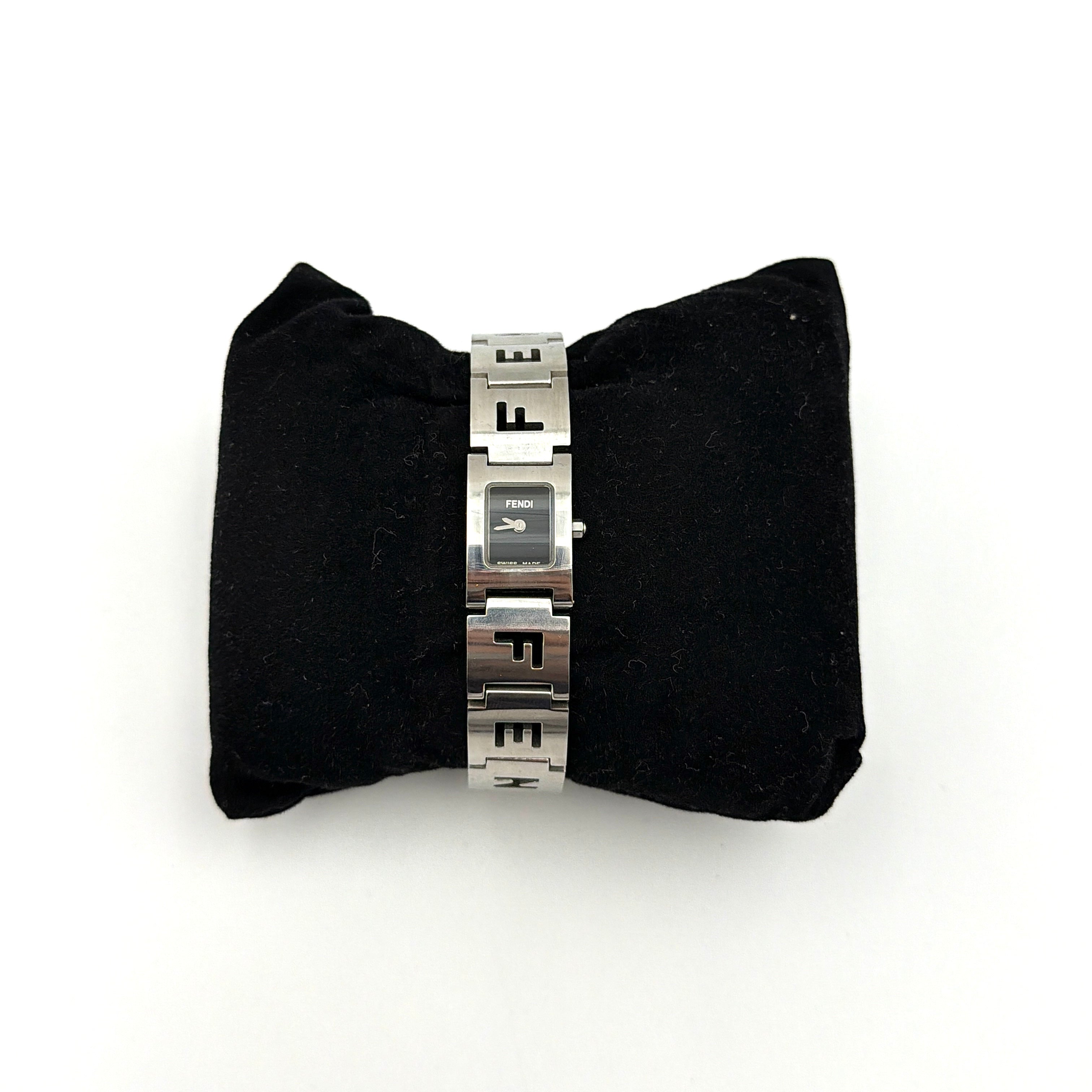 Fendi 3150L FF Logo Belt Watch in silver with a black dial, presented in a black Fendi box with gold logo accents.