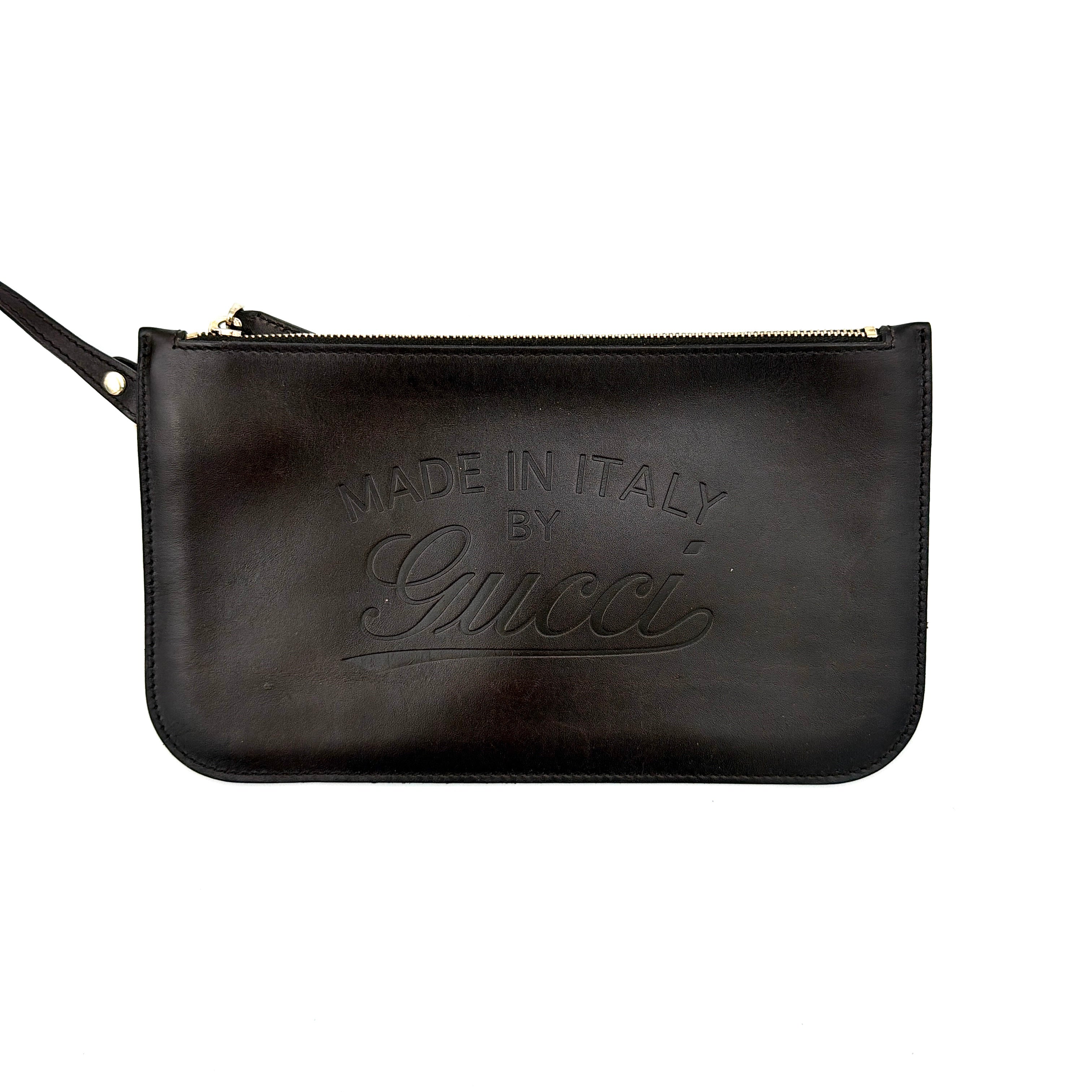 Gucci beige canvas shoulder bag with brown leather trim, bold Gucci logo, and matching detachable leather pouch.