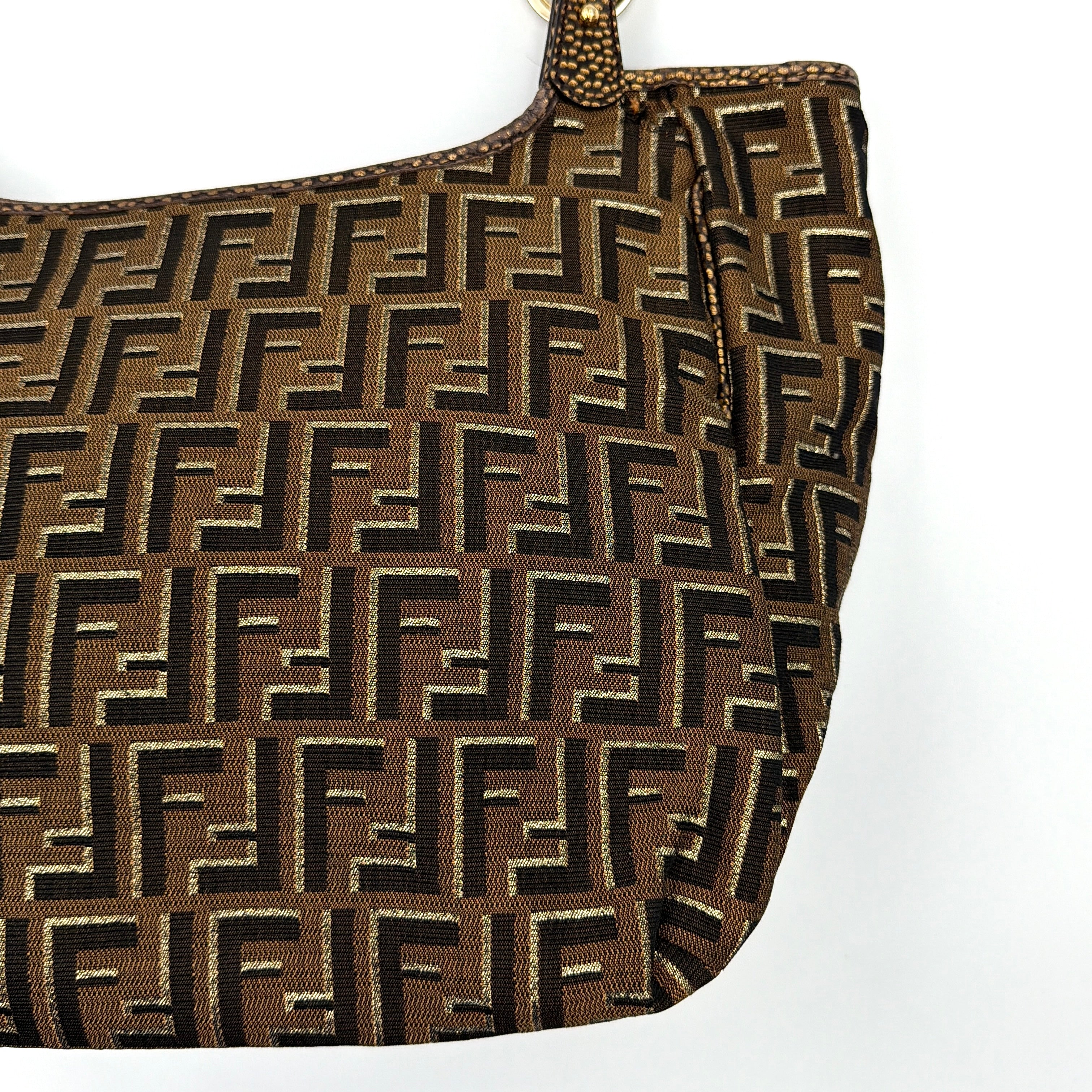 The Fendi FF Zucca Chef Shoulder Bag in brown jacquard canvas with all-over FF monogram, leather trim, and gold-tone ring handles.