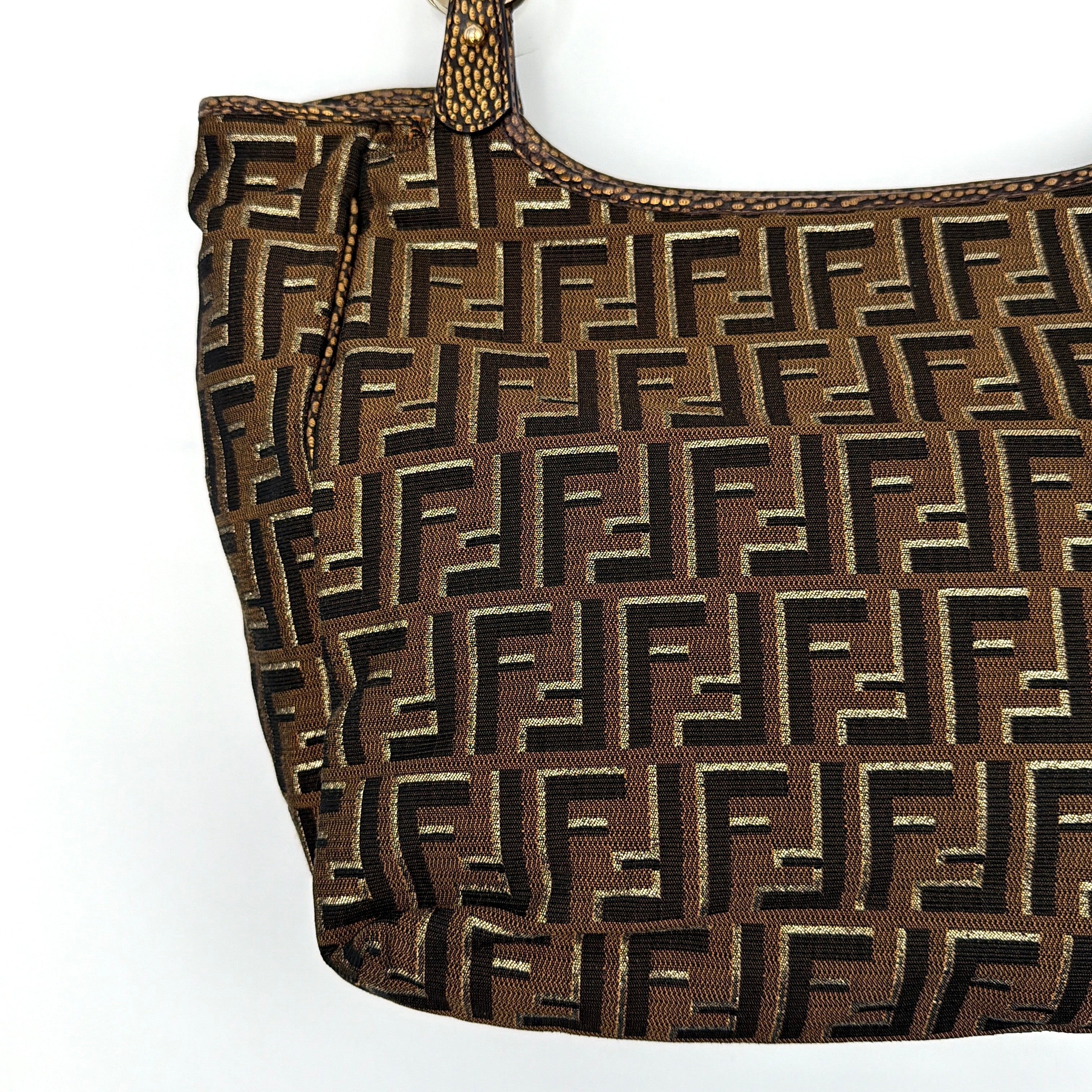 The Fendi FF Zucca Chef Shoulder Bag in brown jacquard canvas with all-over FF monogram, leather trim, and gold-tone ring handles.
