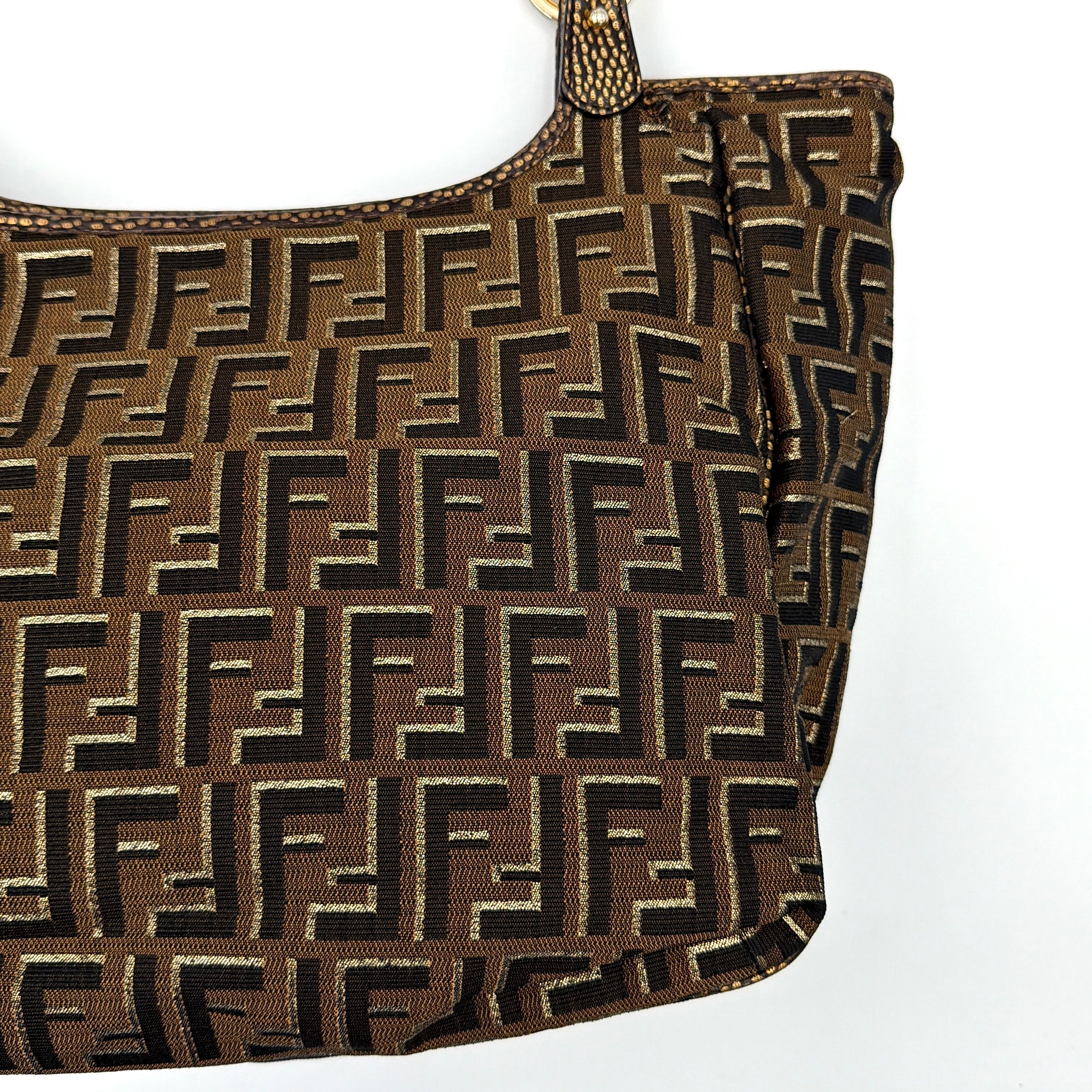 The Fendi FF Zucca Chef Shoulder Bag in brown jacquard canvas with all-over FF monogram, leather trim, and gold-tone ring handles.