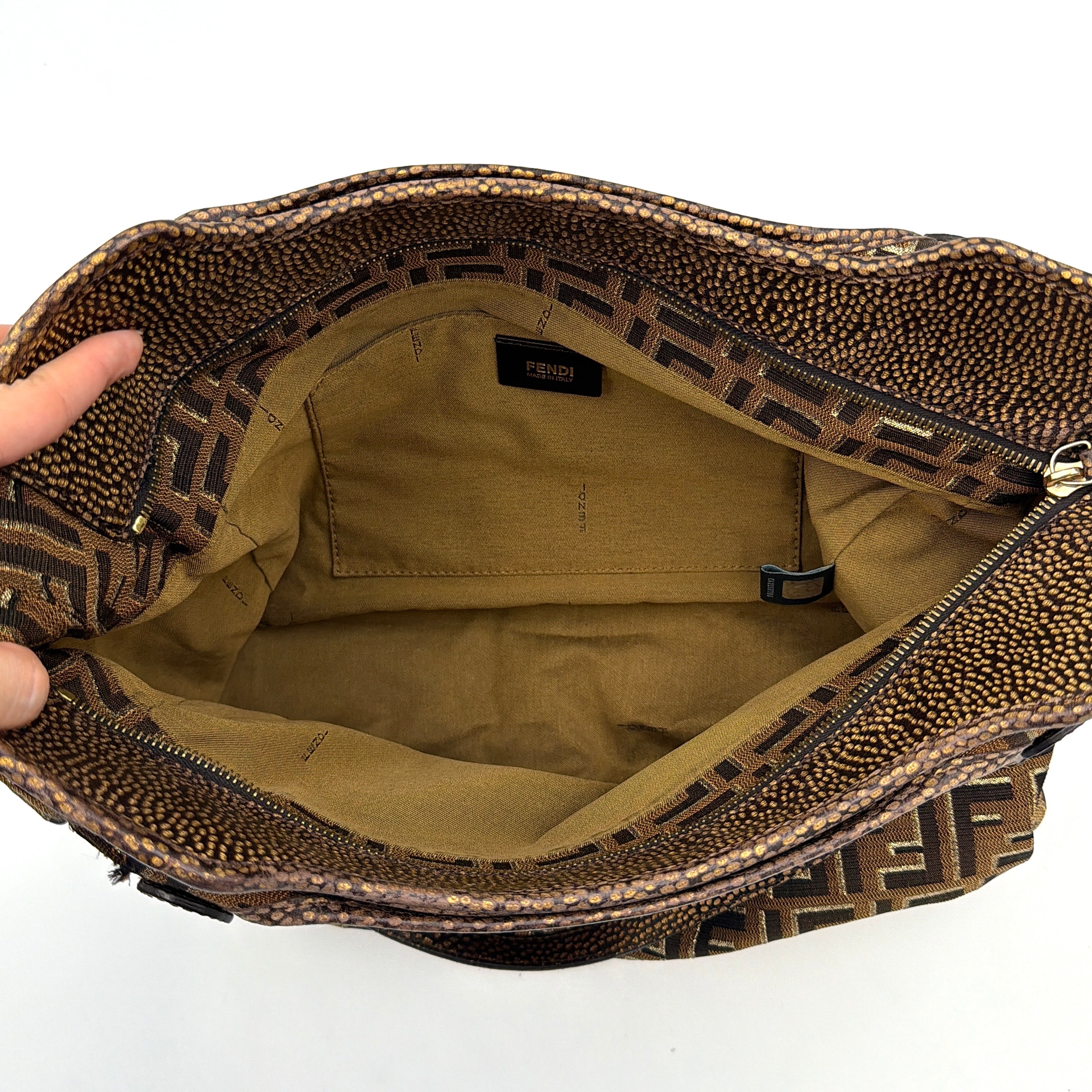 The Fendi FF Zucca Chef Shoulder Bag in brown jacquard canvas with all-over FF monogram, leather trim, and gold-tone ring handles.