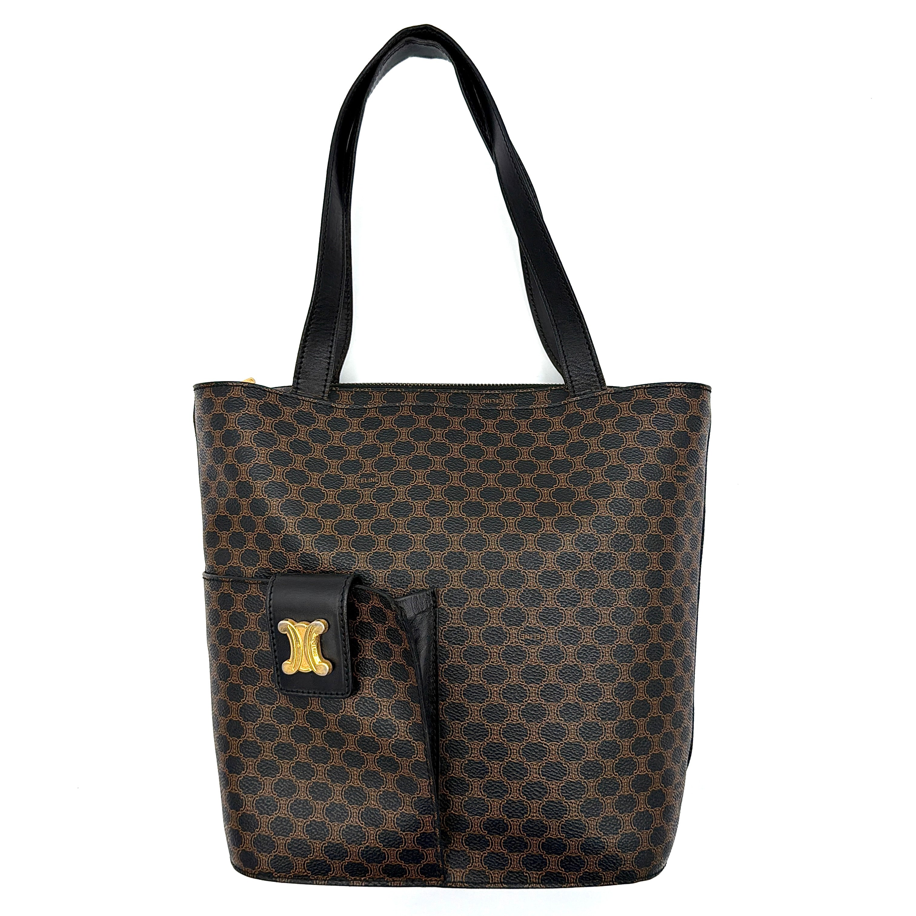 Celine Macadam Blason Tote Bag in brown coated canvas with all-over Macadam motif, black leather trim, and gold-tone Blason emblem front pocket.
