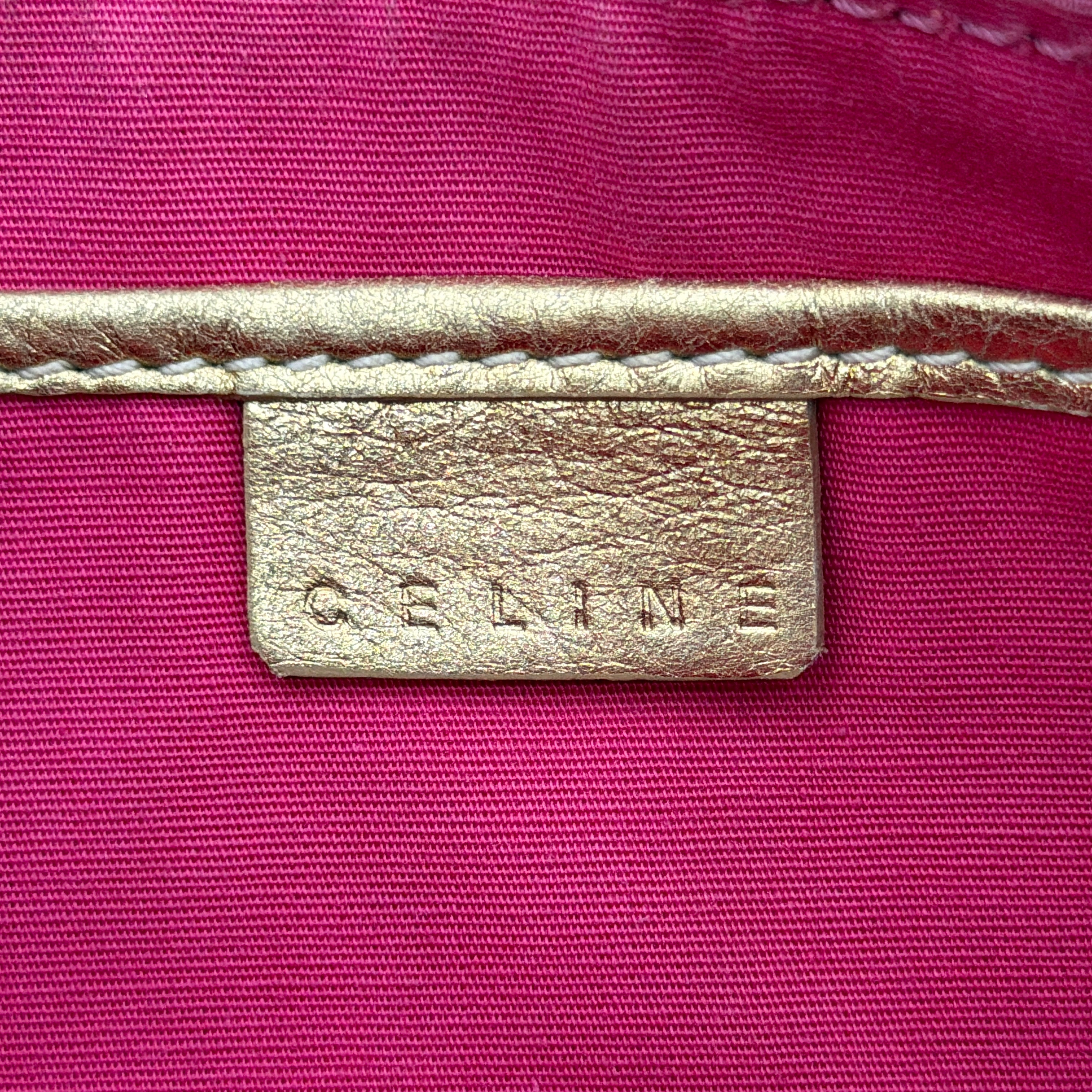 Front view of the Celine Macadam pink denim shoulder bag with gold-tone leather strap and triomphe monogram print.