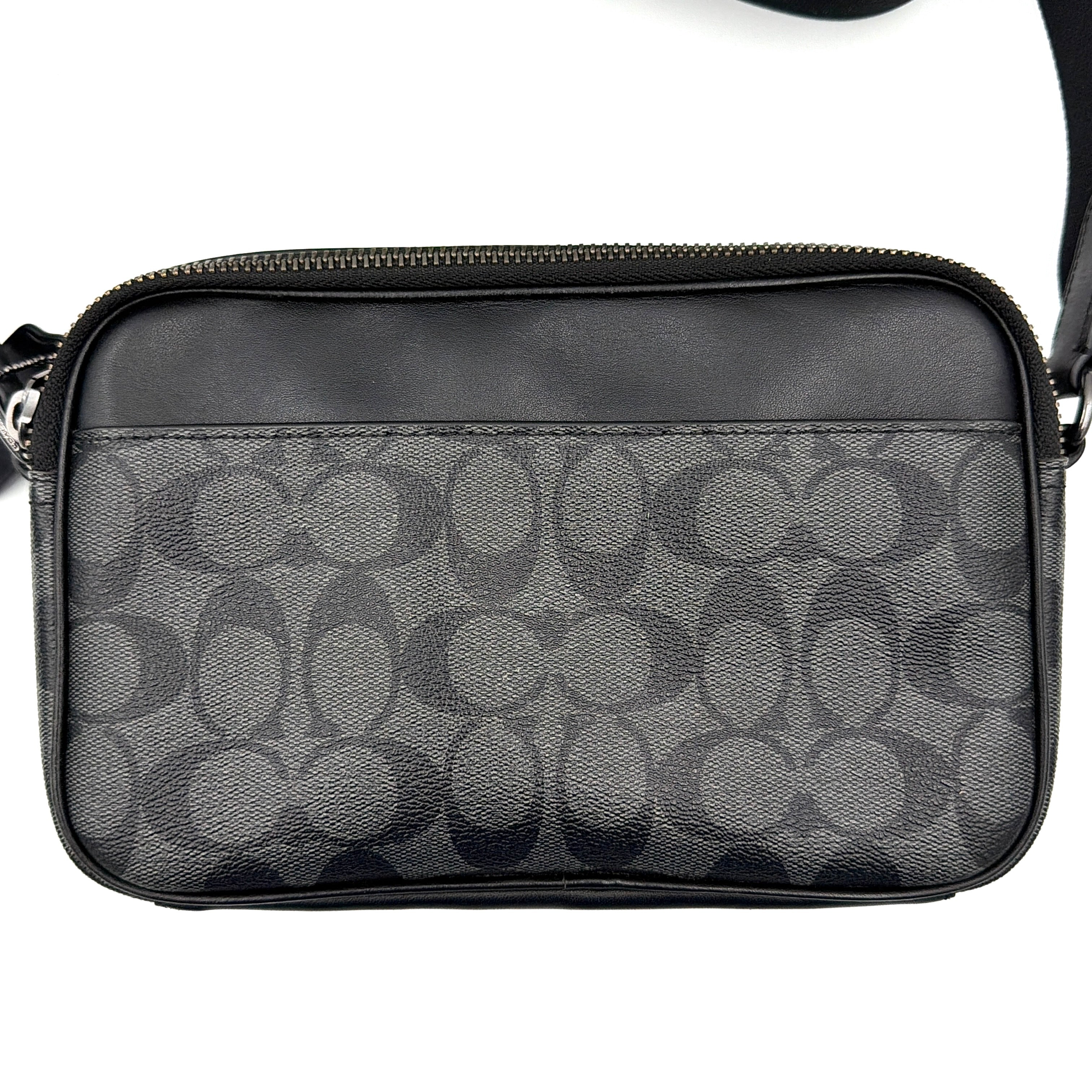 Coach Signature Graham Crossbody Bag in grey and black with adjustable web strap and silver-tone hardware, presented against a white background.