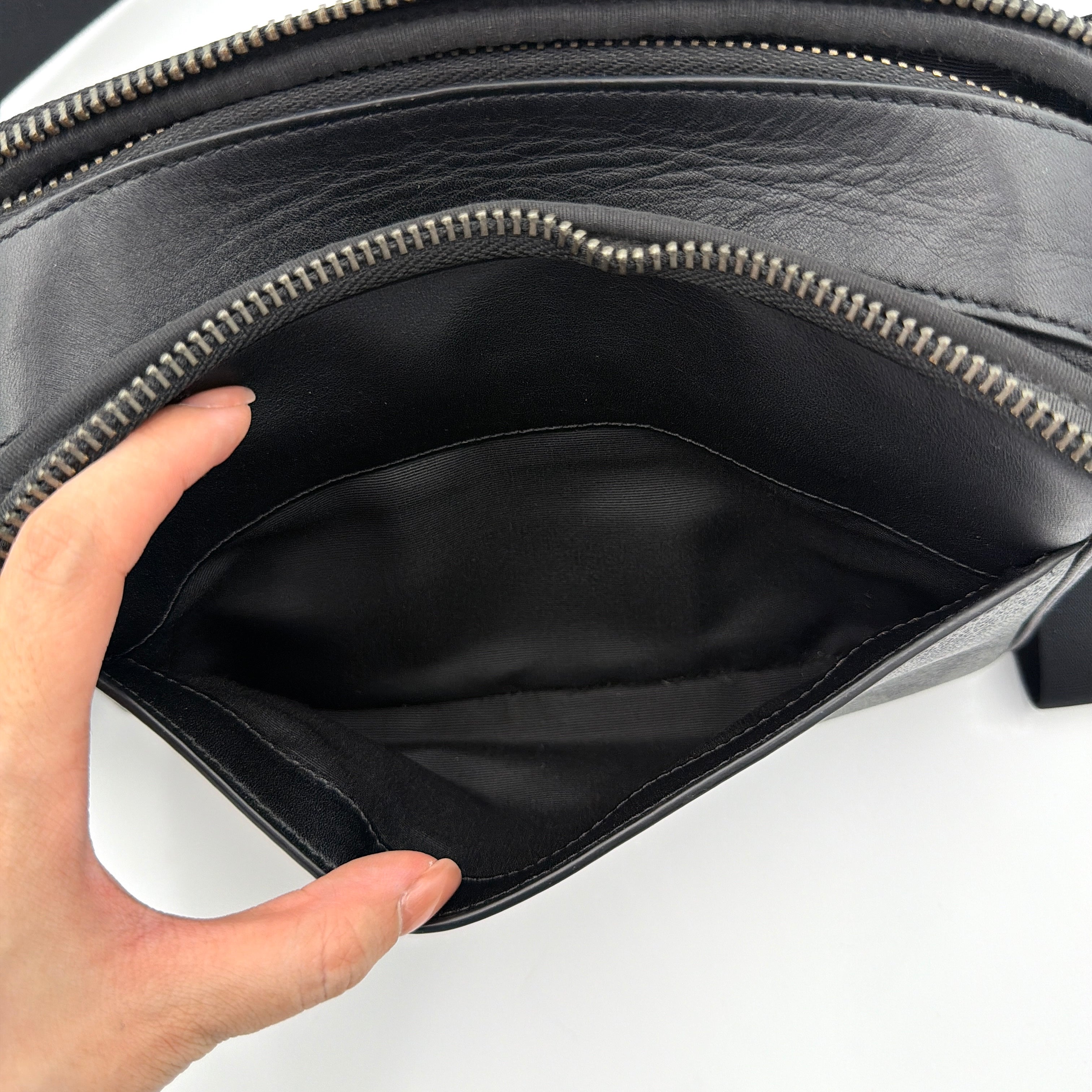 Coach Signature Graham Crossbody Bag in grey and black with adjustable web strap and silver-tone hardware, presented against a white background.
