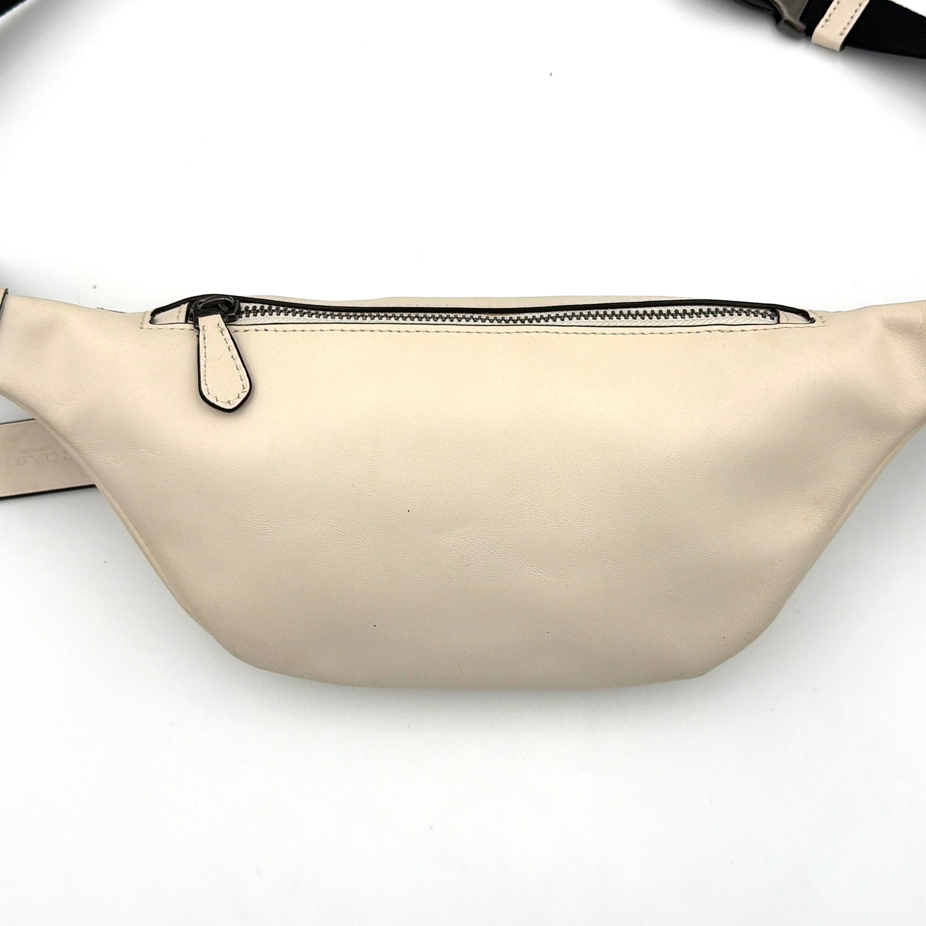 Coach Mini Warren belt bag in cream canvas with tan horse and carriage motif, leather trim, and black adjustable strap.