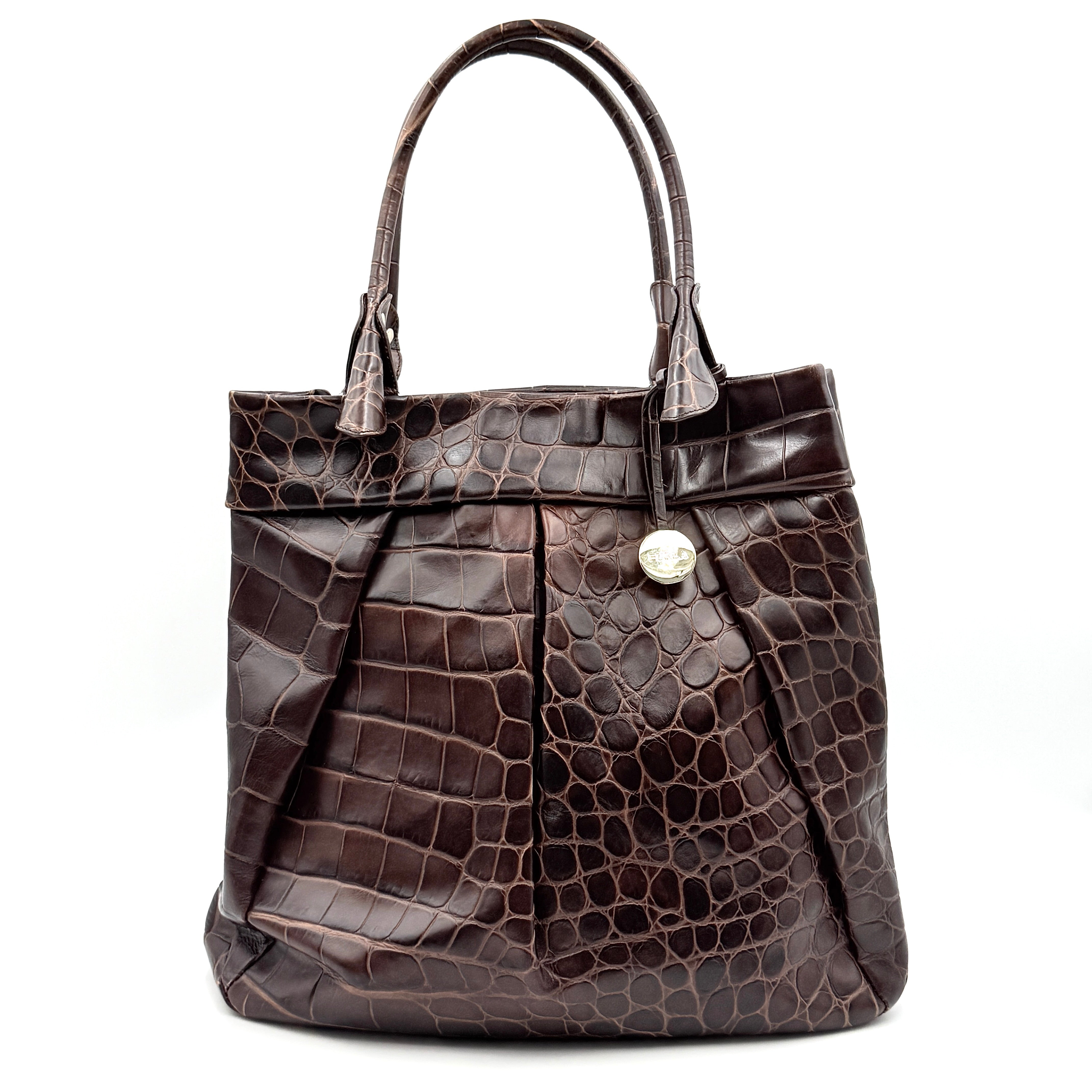 Furla dark brown croc-embossed leather tote bag with gold logo charm, structured silhouette, and double handles.