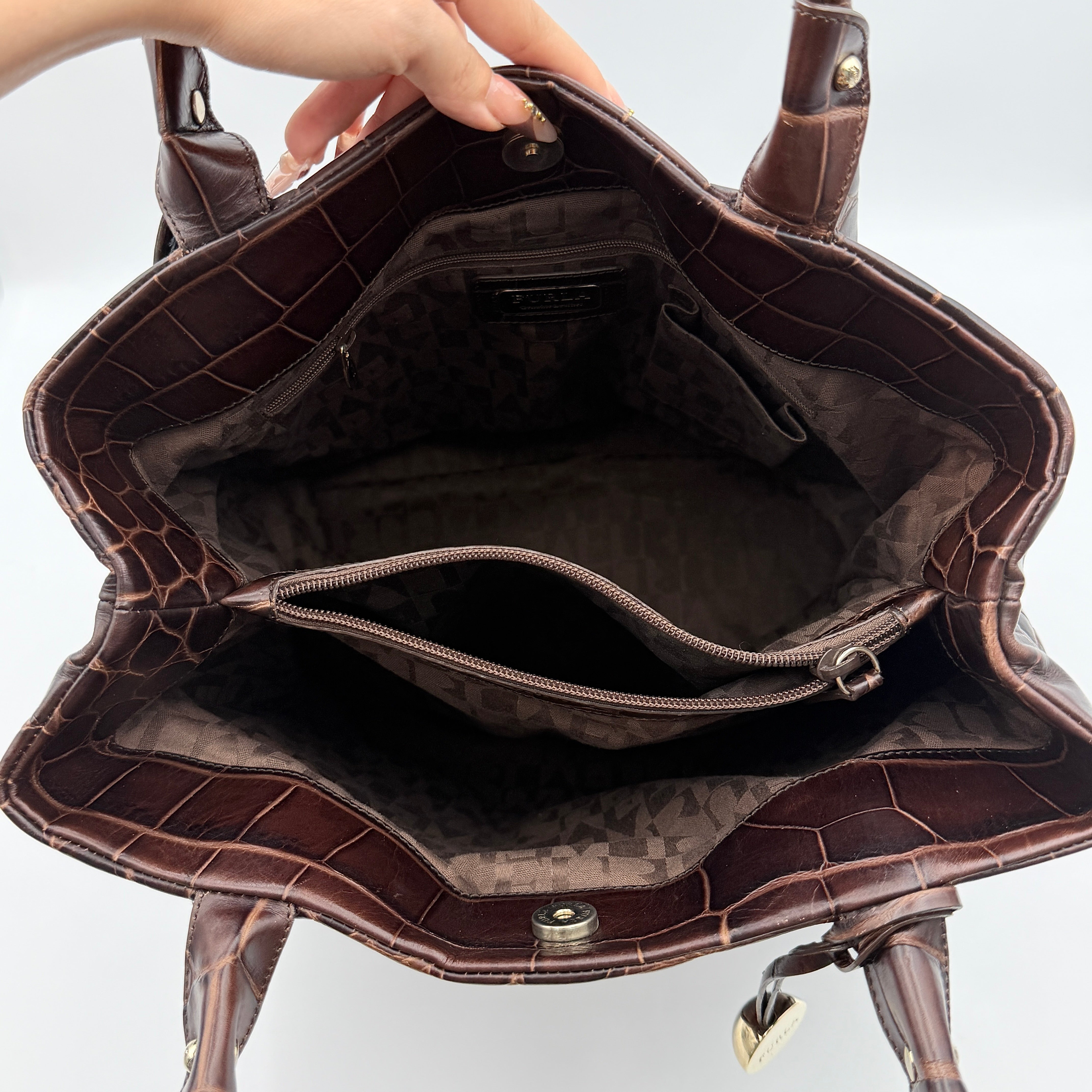 Furla dark brown croc-embossed leather tote bag with gold logo charm, structured silhouette, and double handles.
