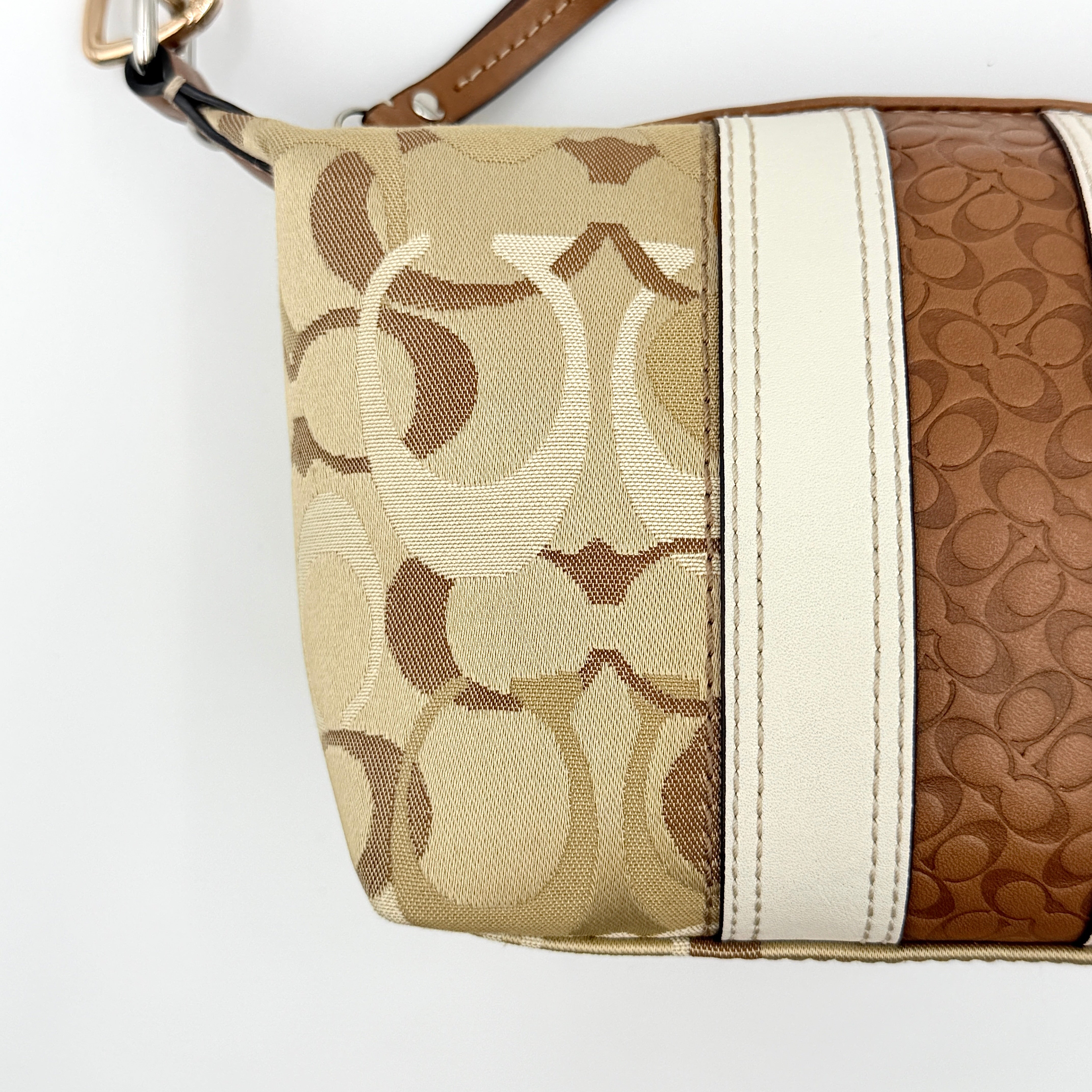 Coach Signature Stripe Mini Hobo Shoulder Bag in brown canvas with white and caramel stripes, featuring a brown leather strap and playful cherry charms.