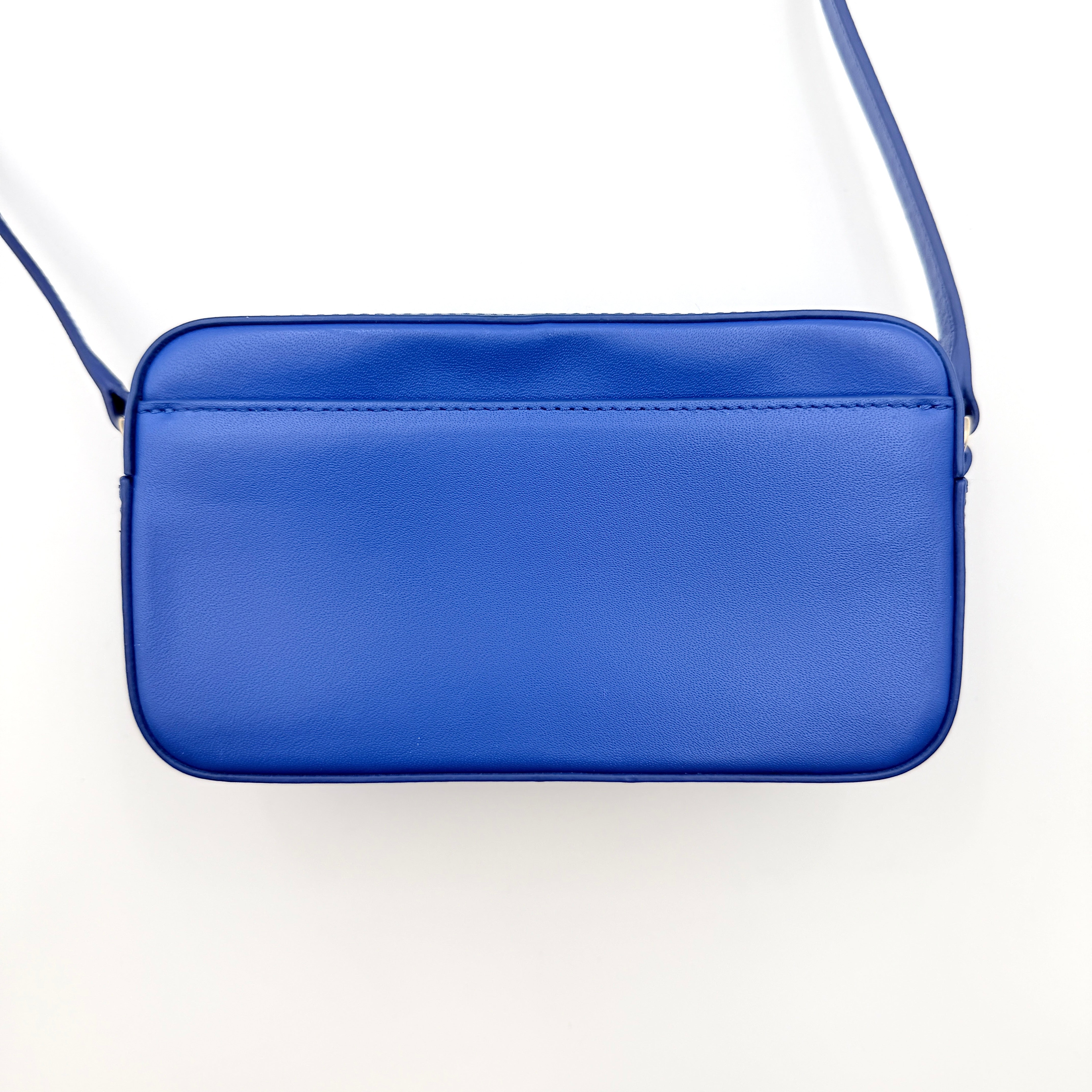Furla Primula Mini Camera Crossbody Bag in vibrant blue leather with embossed logo, shown with adjustable strap.