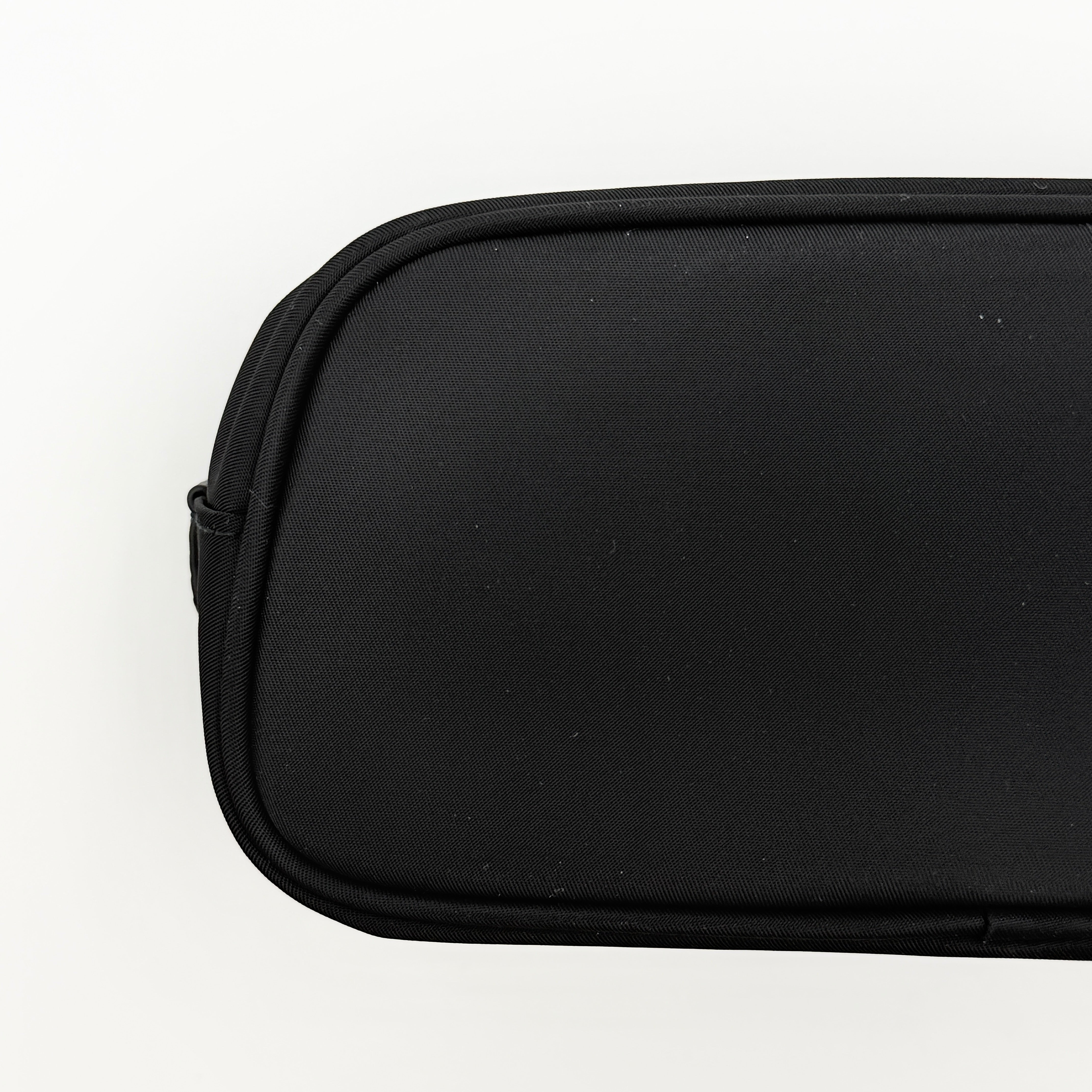 Furla Camelia Cosmetic Case in black nylon with gold logo and wristlet strap, shown with original tag.