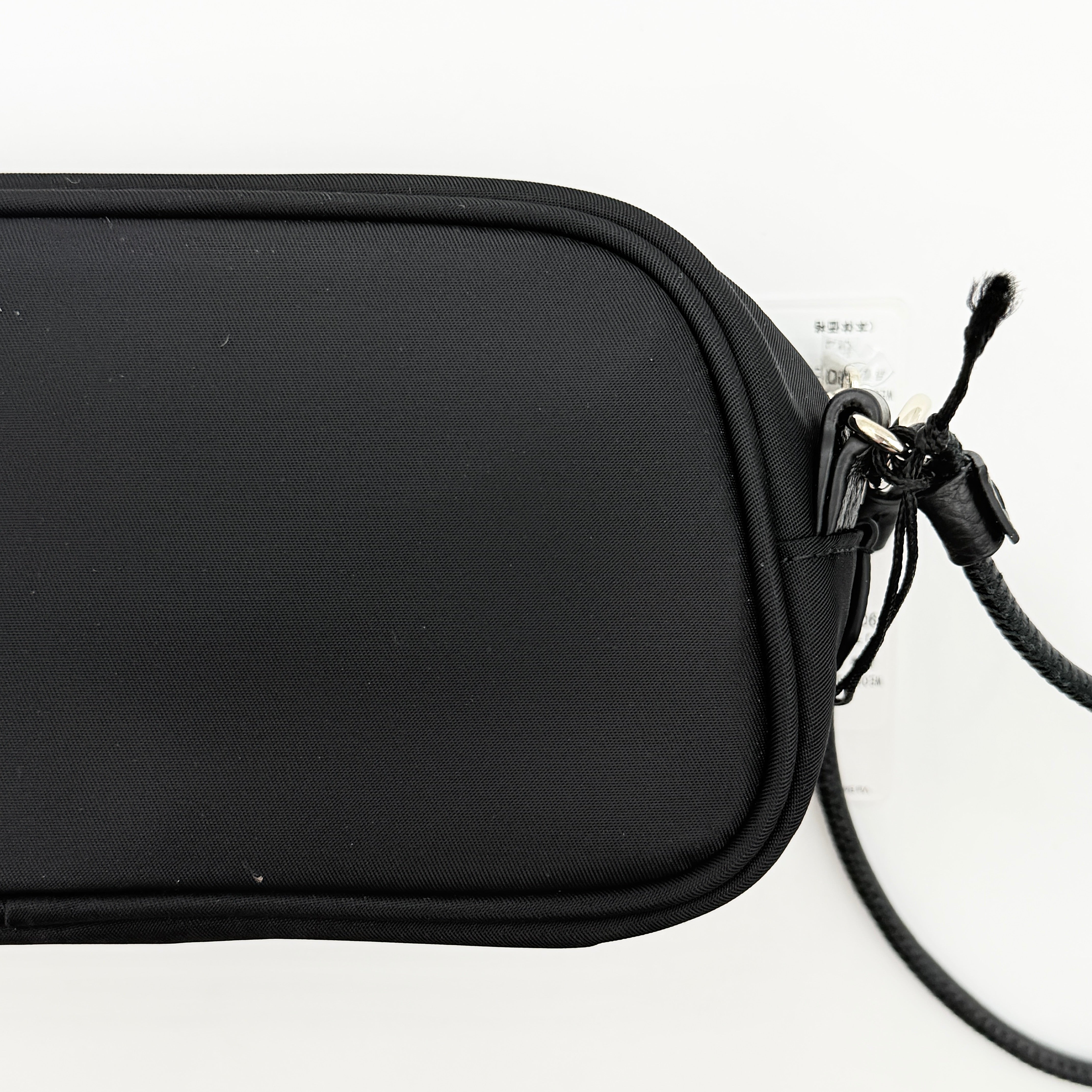 Furla Camelia Cosmetic Case in black nylon with gold logo and wristlet strap, shown with original tag.