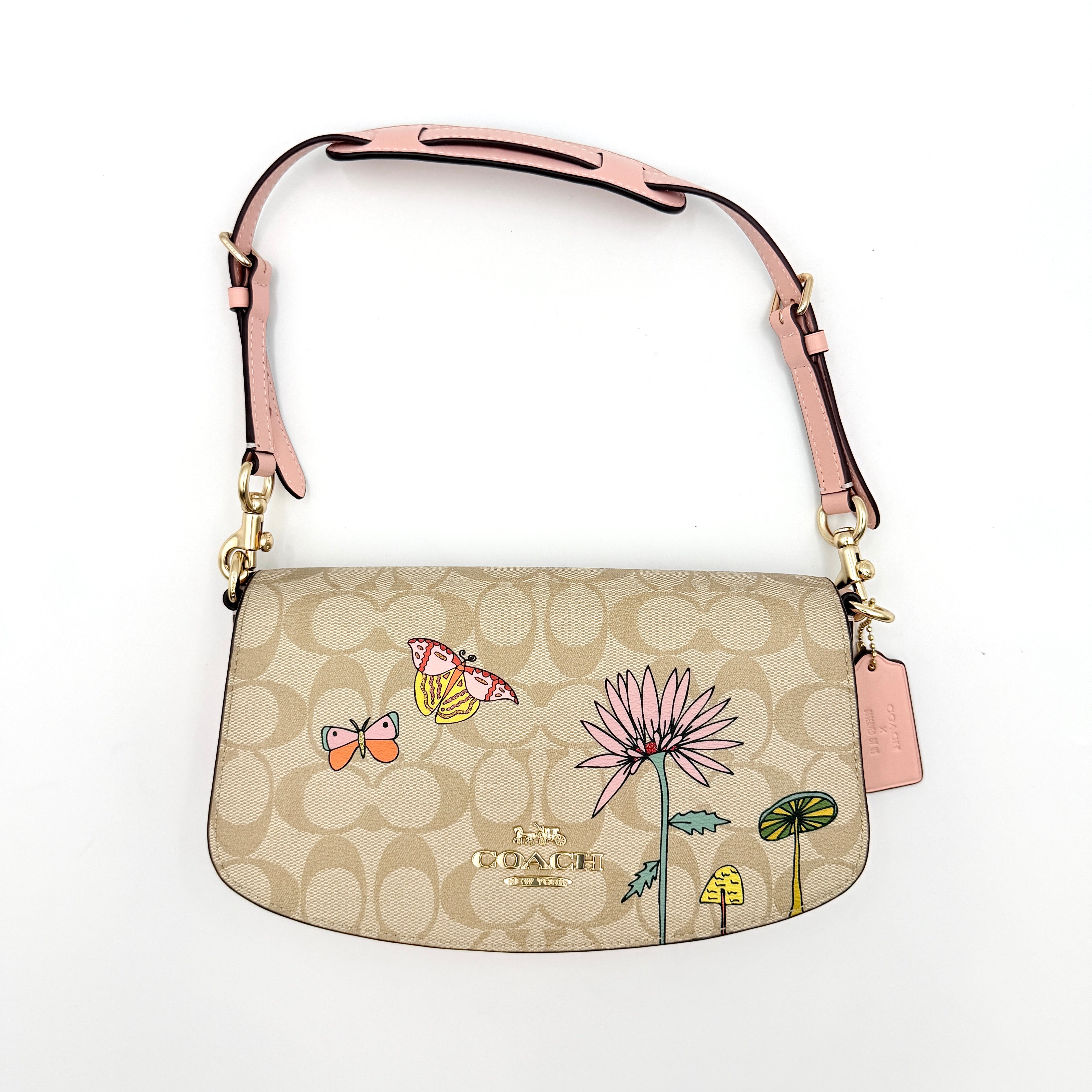 Coach X Observed By Us Andrea Shoulder Bag in beige monogram canvas with pink illustrations and pink leather strap.