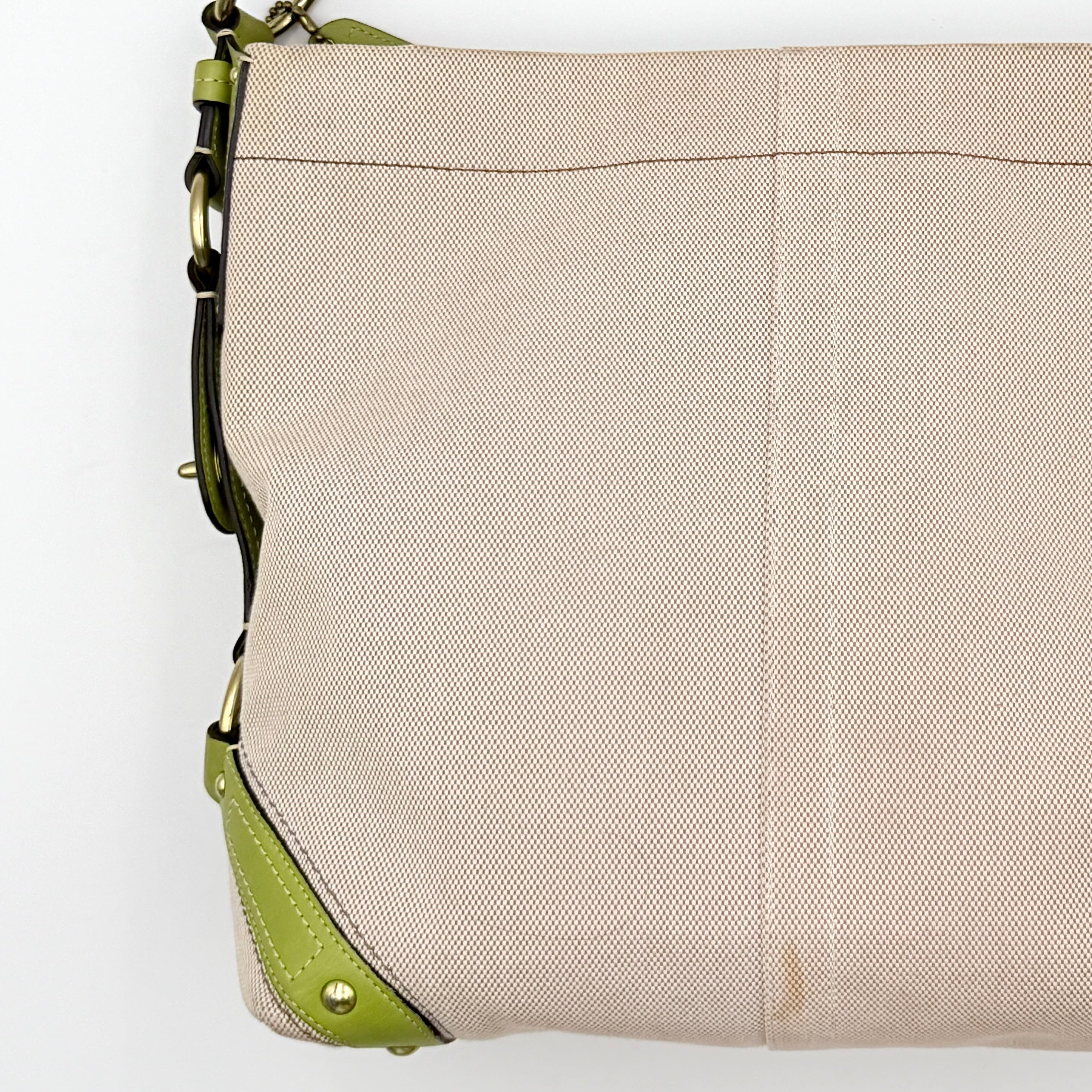 Coach Carly Hobo Shoulder Bag in beige canvas with green leather trim and gold hardware, shown on a white background.