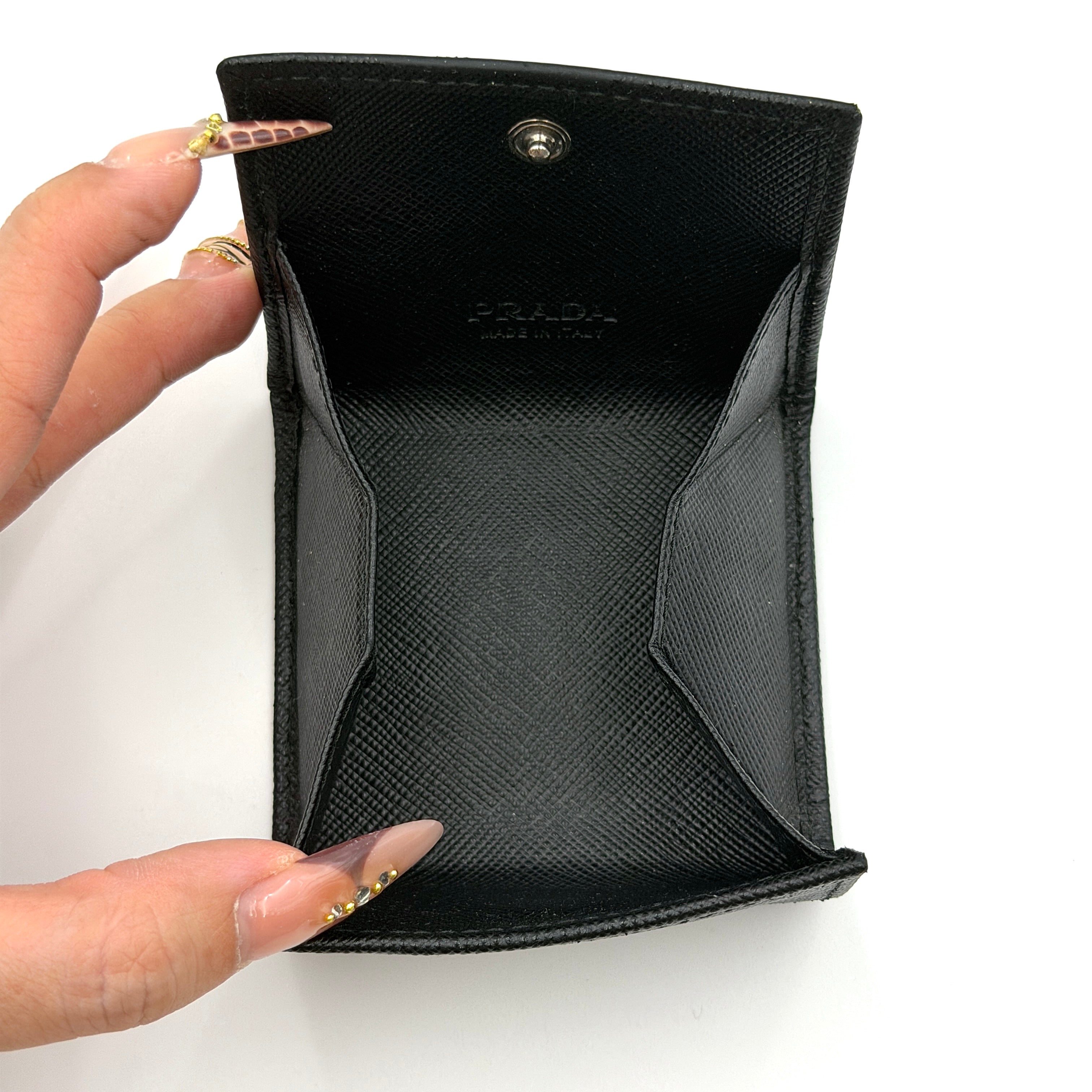 Prada Saffiano Triangle Logo Coin Case in black with silver enamel logo plaque at the corner.