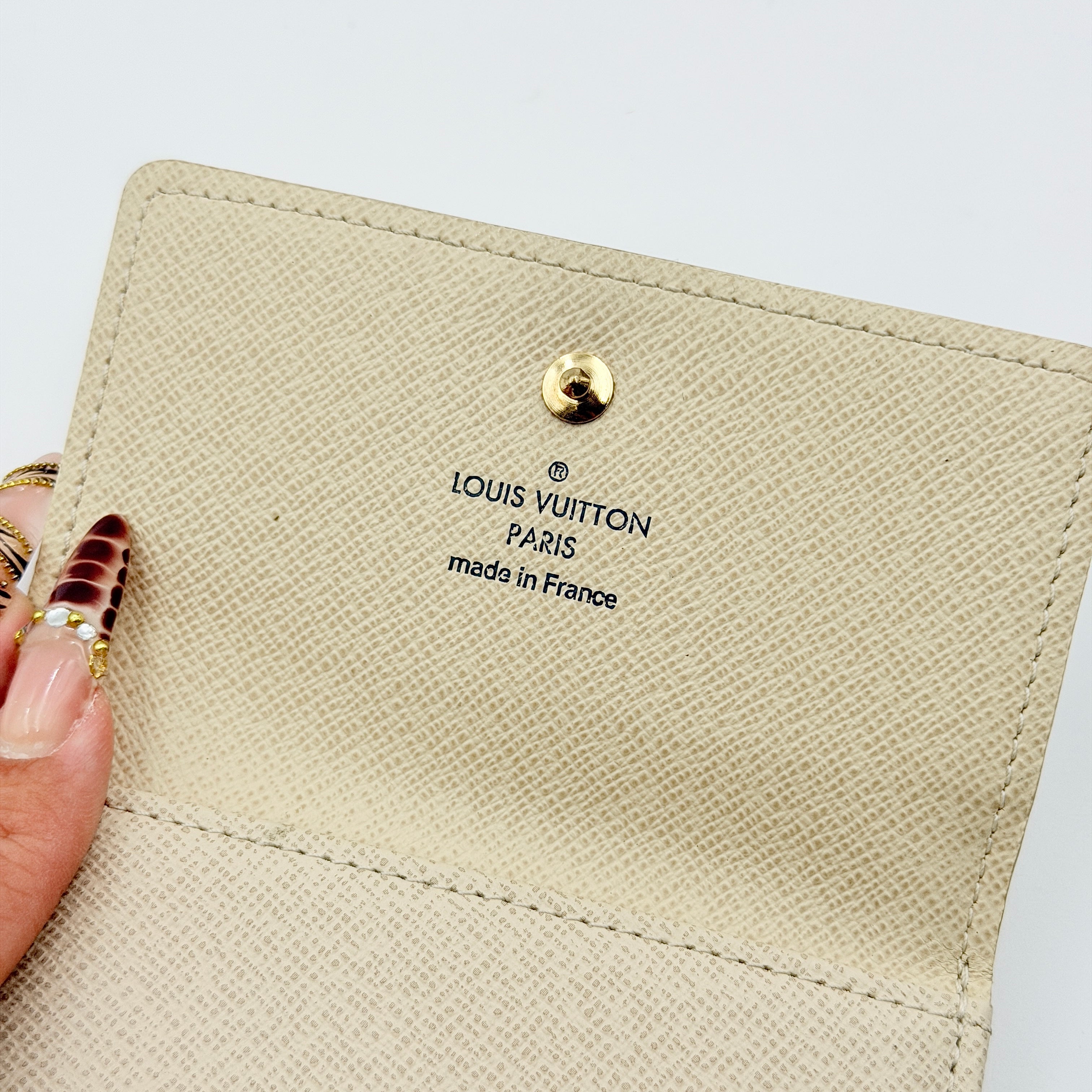 Louis Vuitton Damier Azur Elise Wallet in checked canvas with gold button snap, photographed on a clean white background.