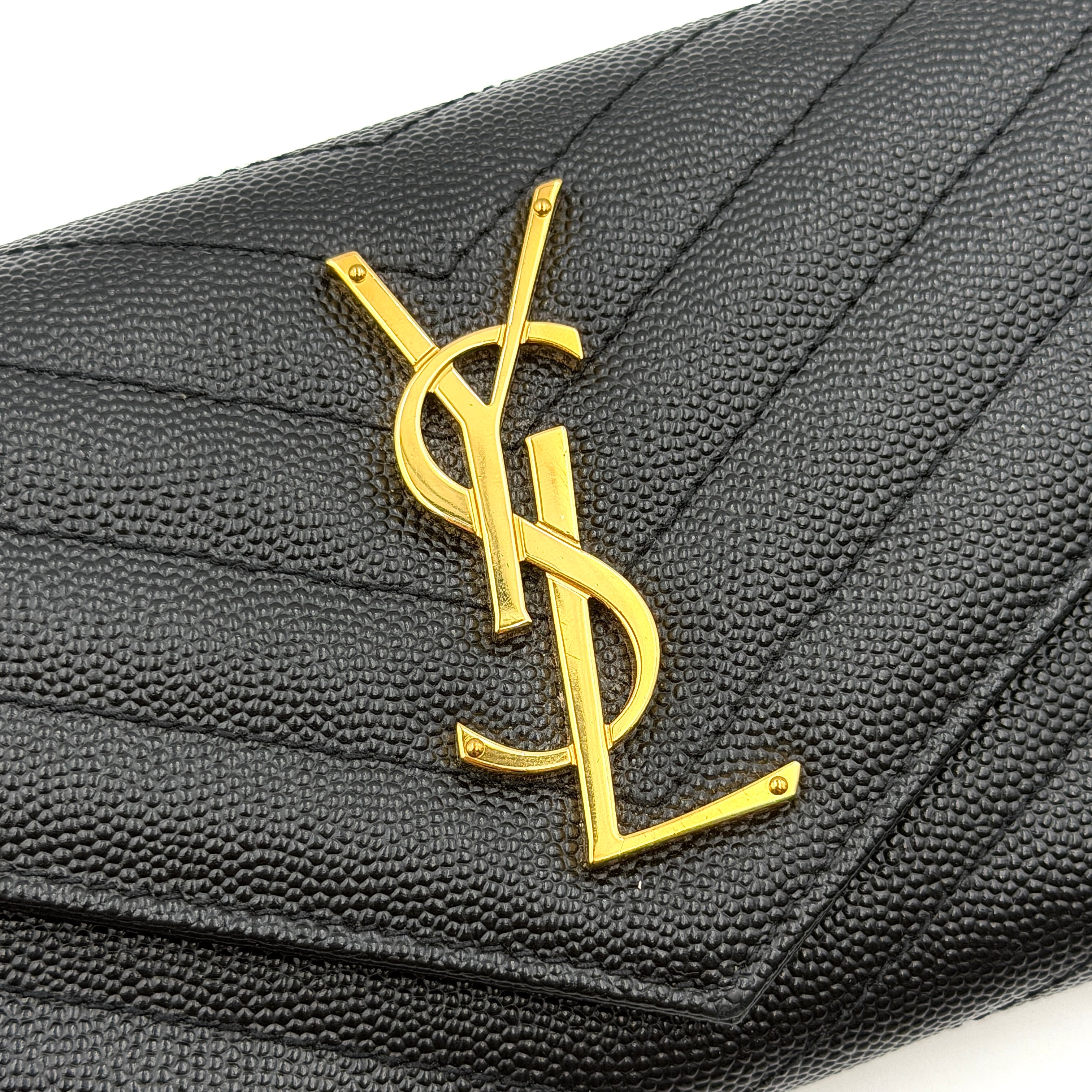 Saint Laurent Cassandre Large Flap Wallet in black grained leather with gold YSL monogram and chevron quilting.