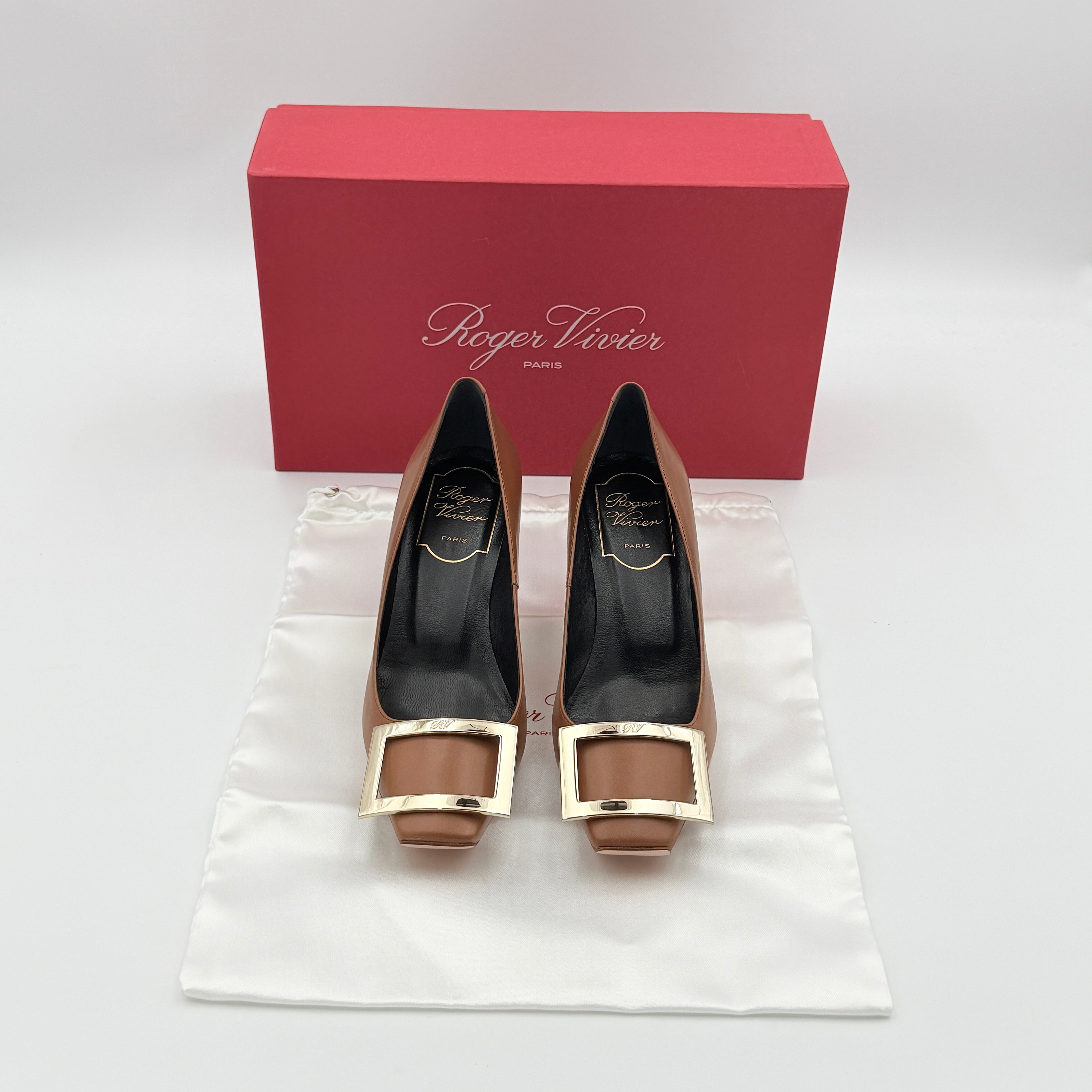 A pair of Roger Vivier Belle Vivier Trompette leather pumps in brown with gold-tone signature buckle and squared toe.