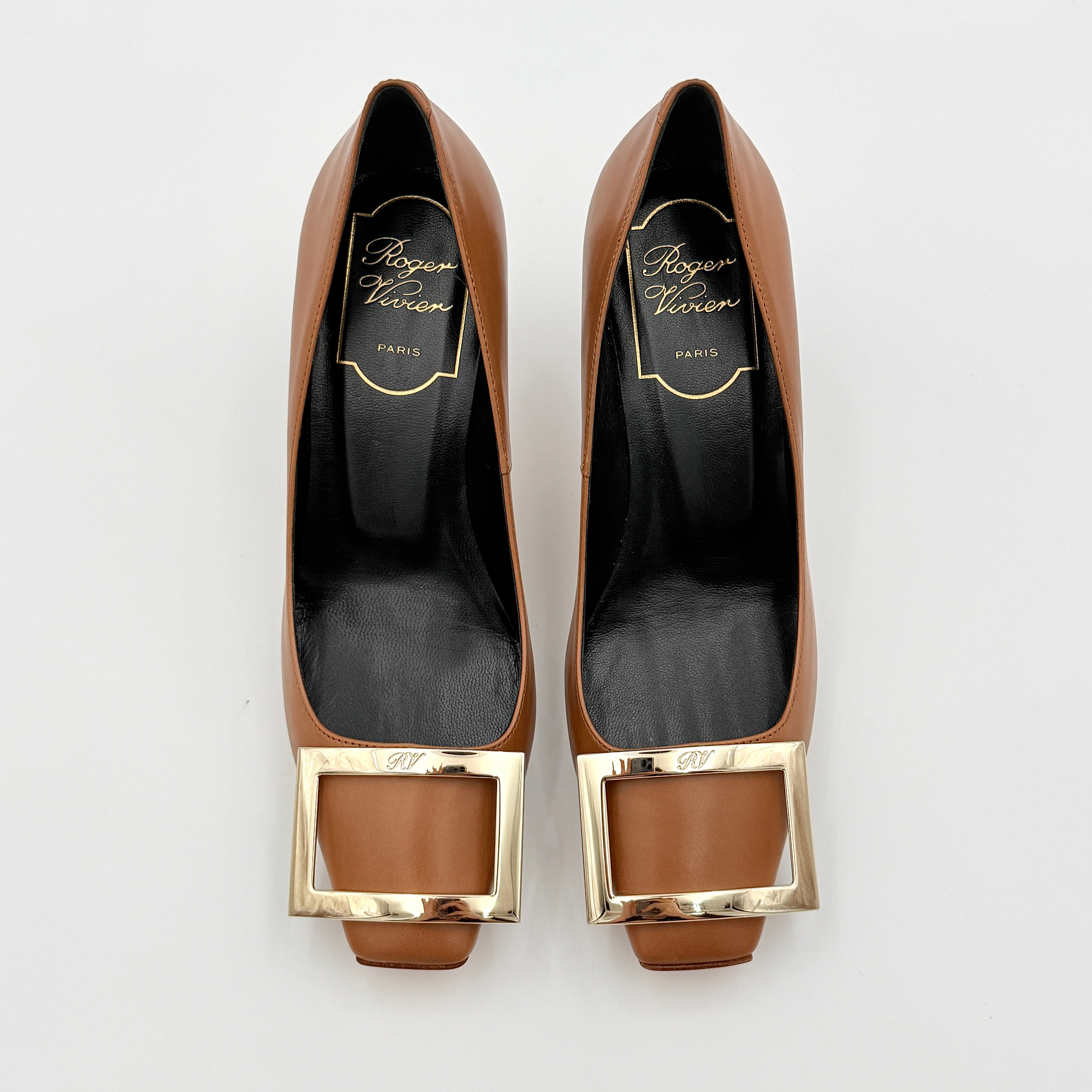 A pair of Roger Vivier Belle Vivier Trompette leather pumps in brown with gold-tone signature buckle and squared toe.
