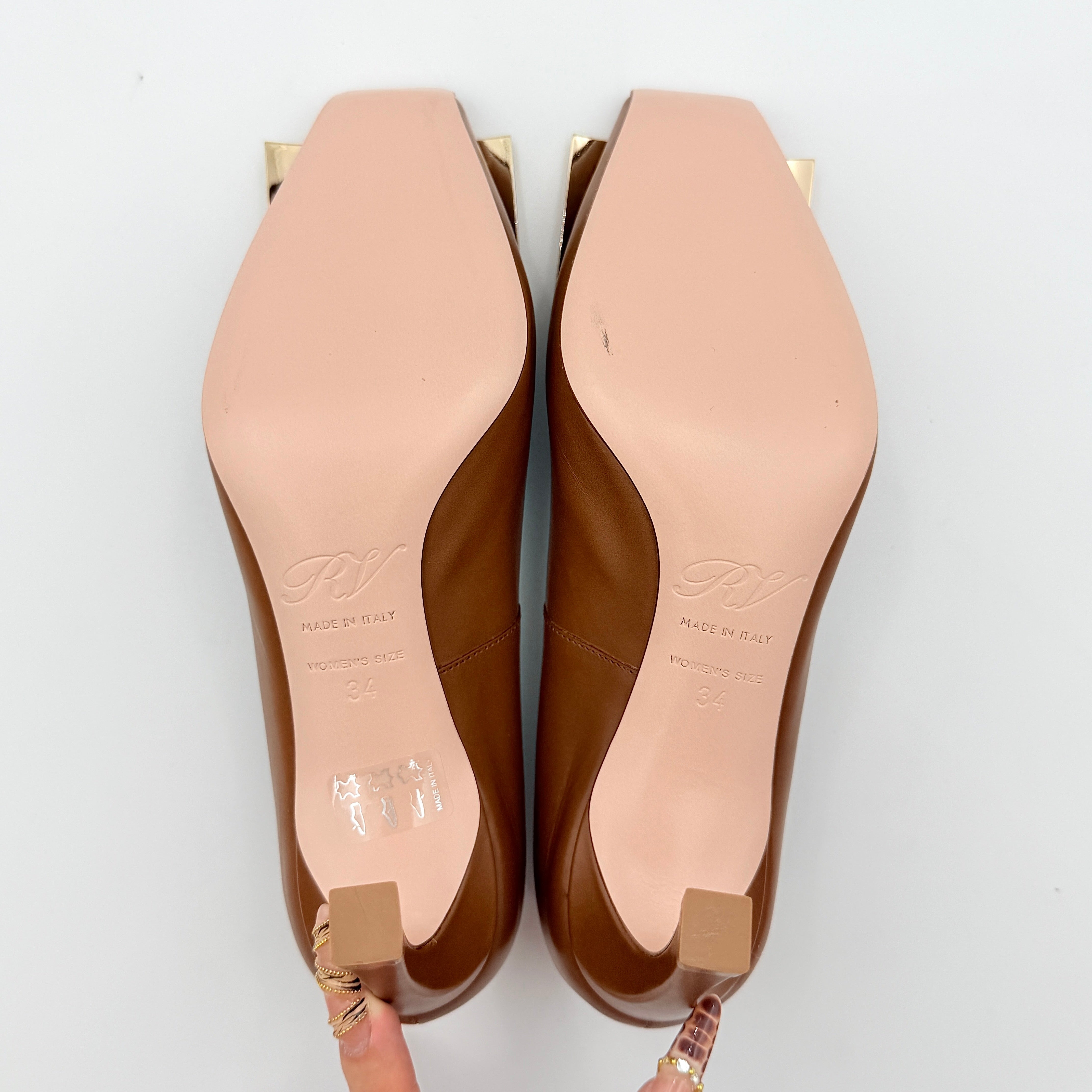 A pair of Roger Vivier Belle Vivier Trompette leather pumps in brown with gold-tone signature buckle and squared toe.