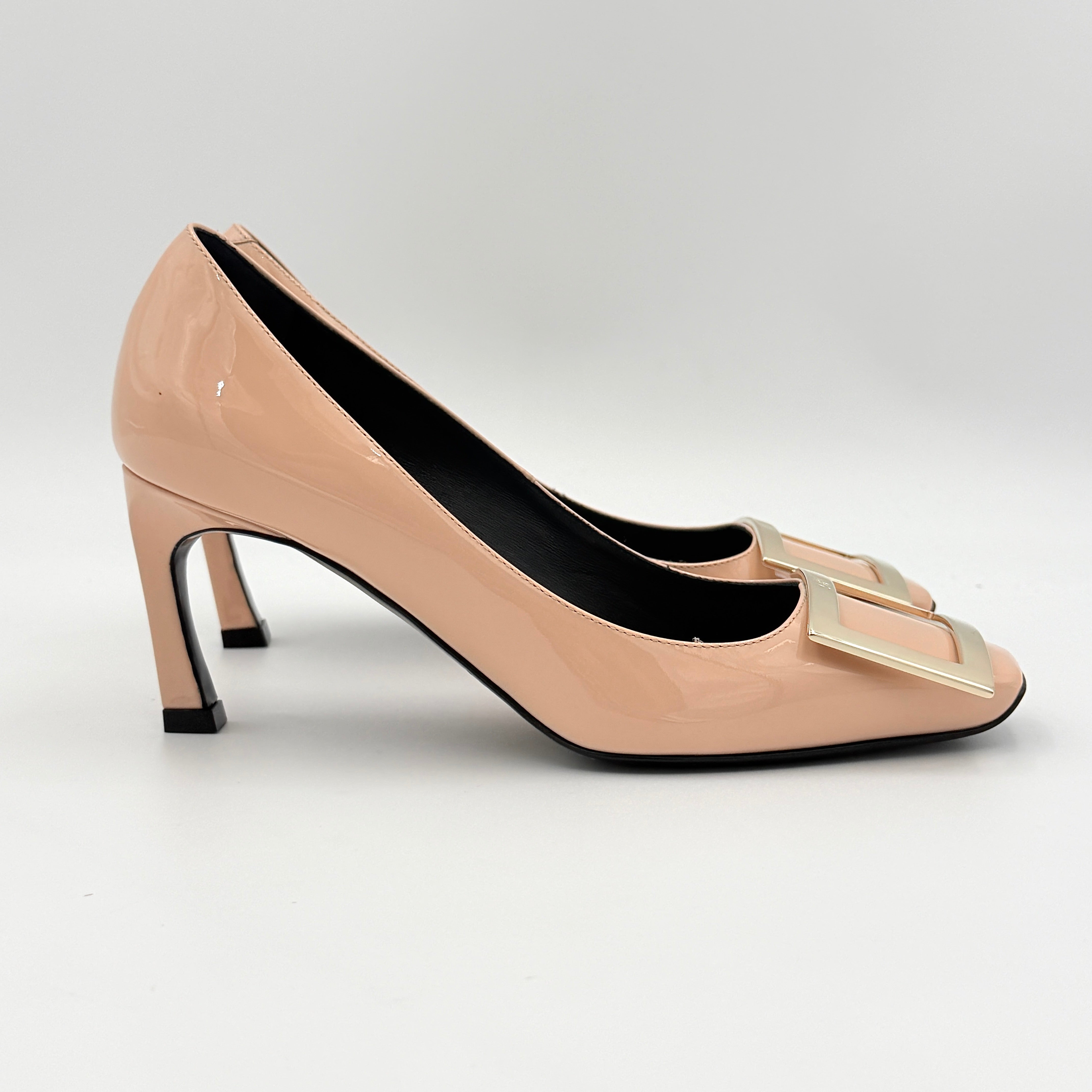 A pair of Roger Vivier Belle Vivier Trompette pumps in patent blush pink leather with signature gold buckles at the toe.
