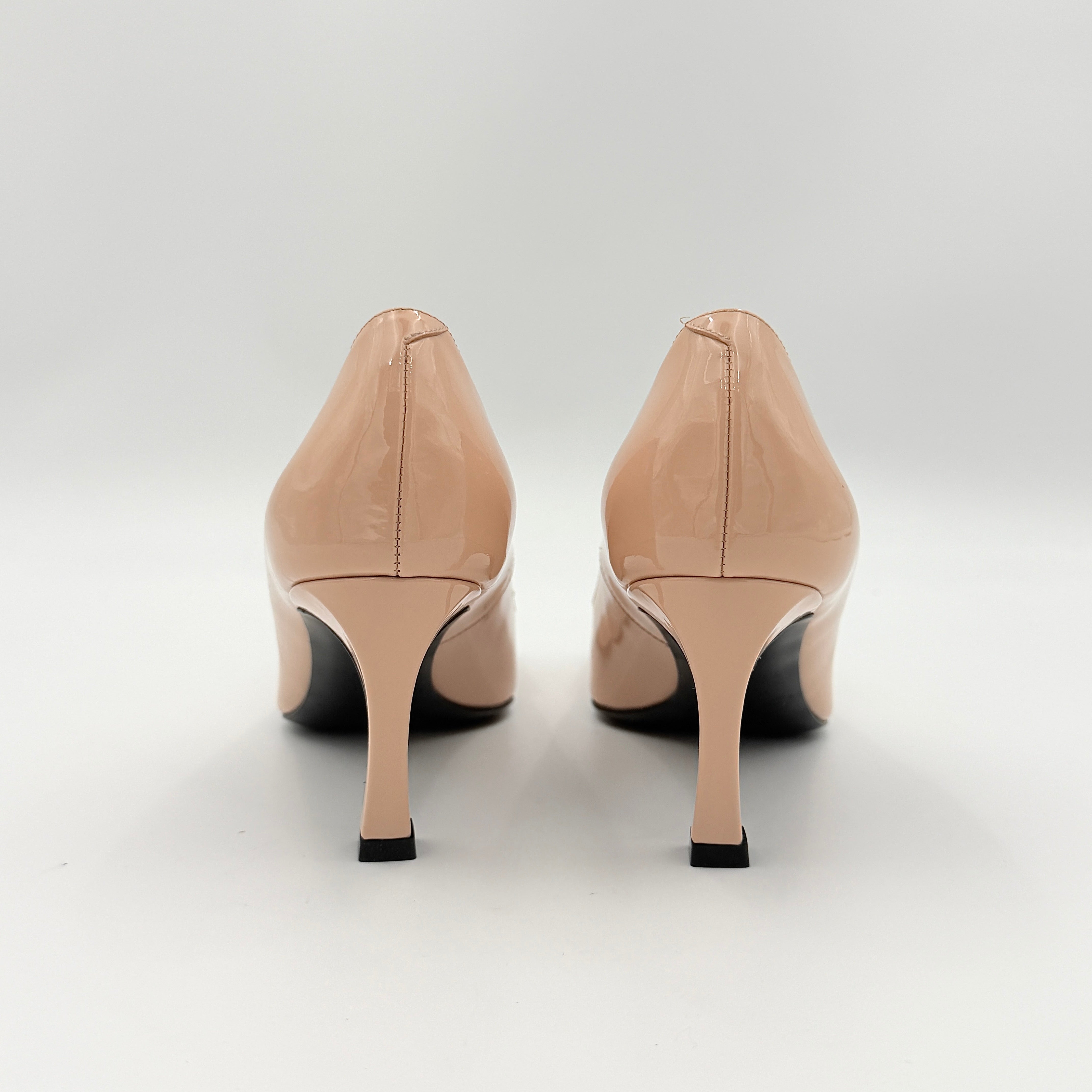 A pair of Roger Vivier Belle Vivier Trompette pumps in patent blush pink leather with signature gold buckles at the toe.