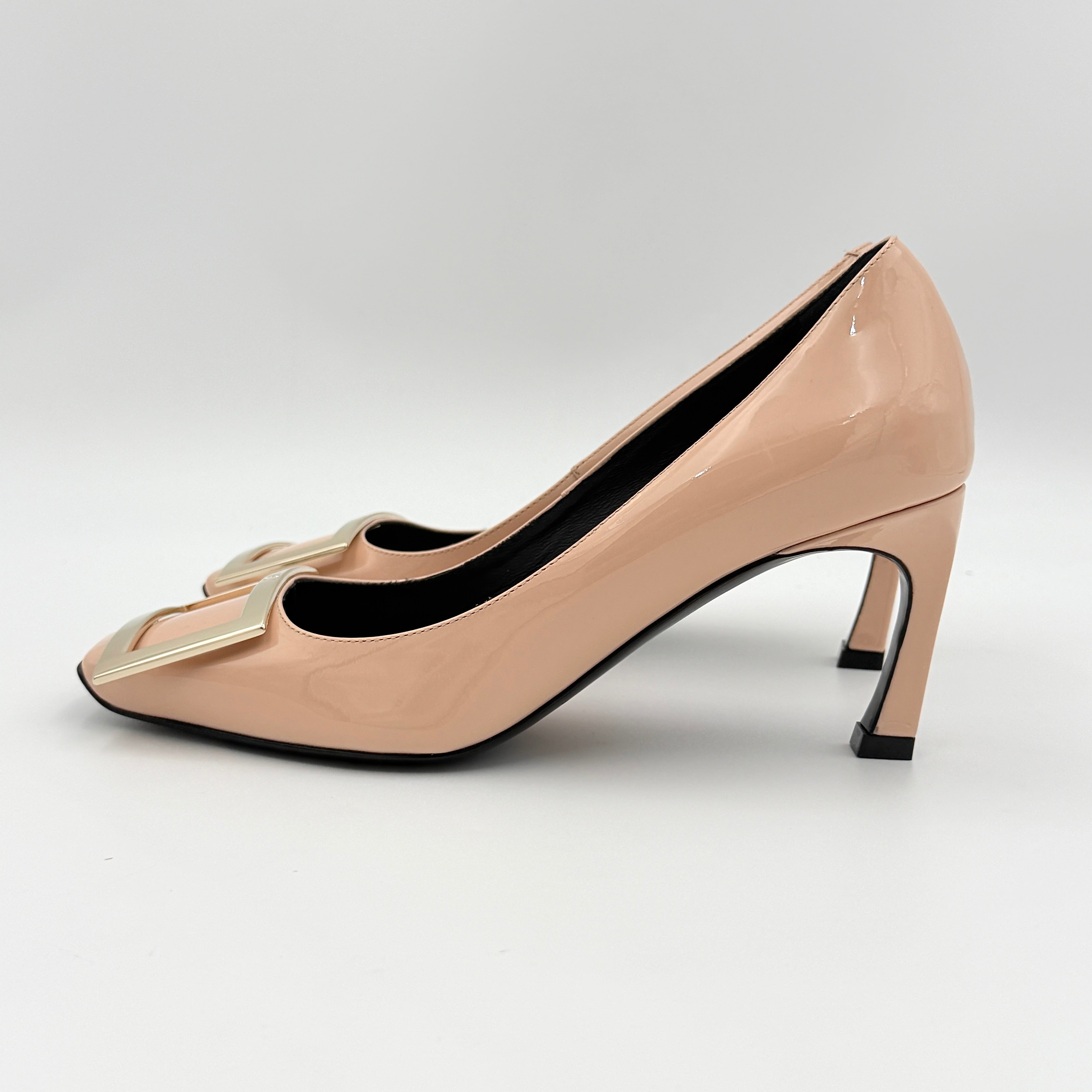 A pair of Roger Vivier Belle Vivier Trompette pumps in patent blush pink leather with signature gold buckles at the toe.