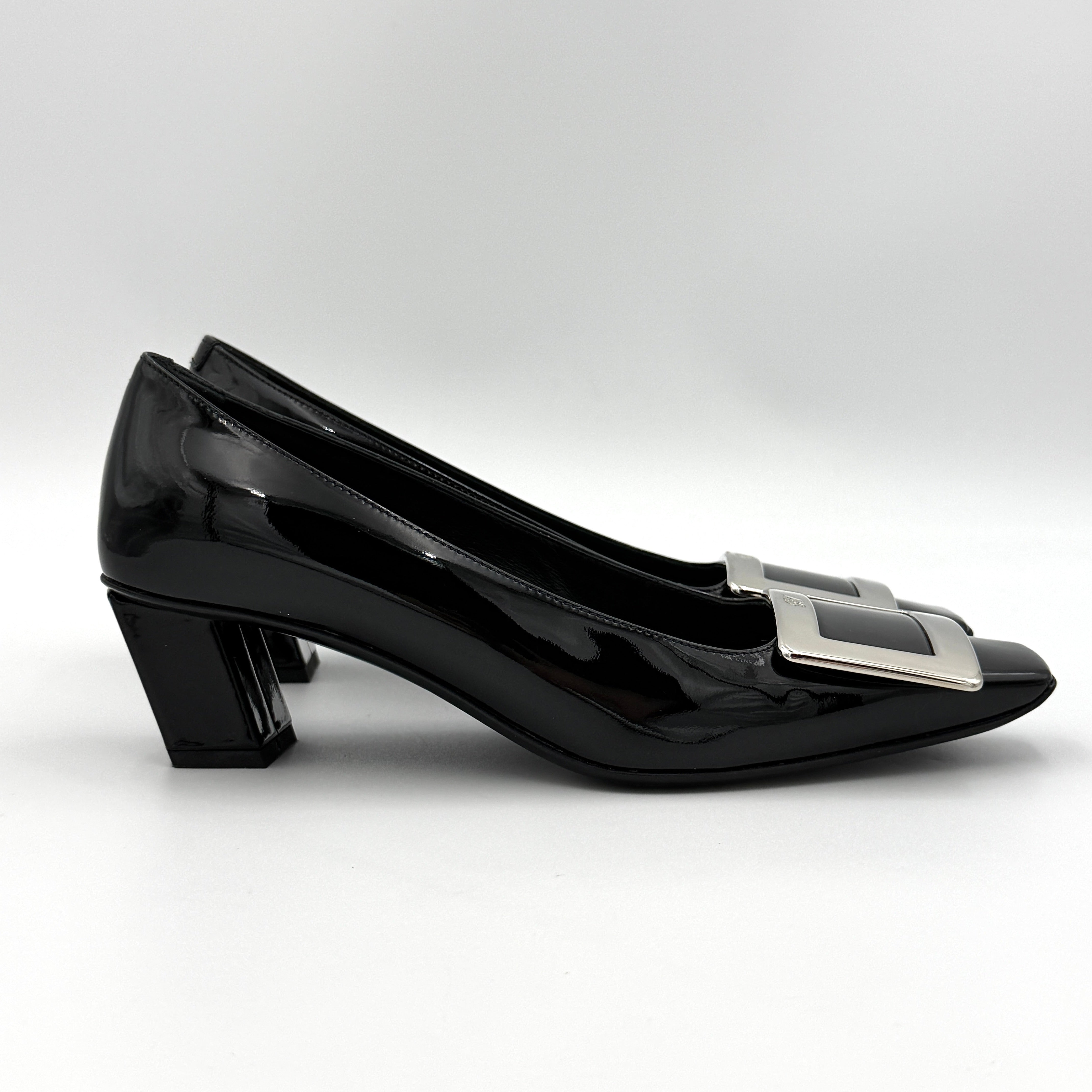 A pair of Roger Vivier Belle Vivier black patent pumps with signature silver-tone buckles, displayed at an angle.