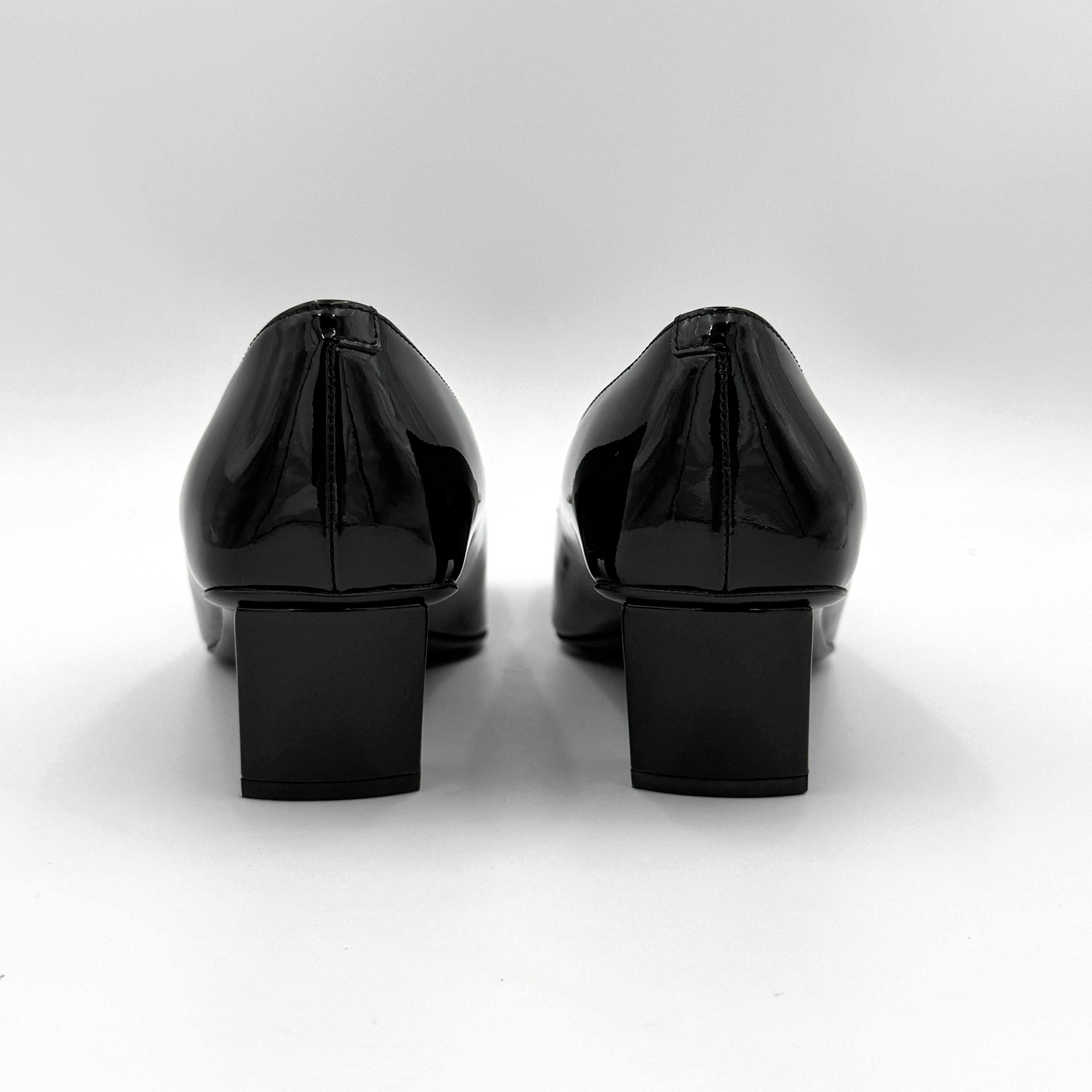 A pair of Roger Vivier Belle Vivier black patent pumps with signature silver-tone buckles, displayed at an angle.