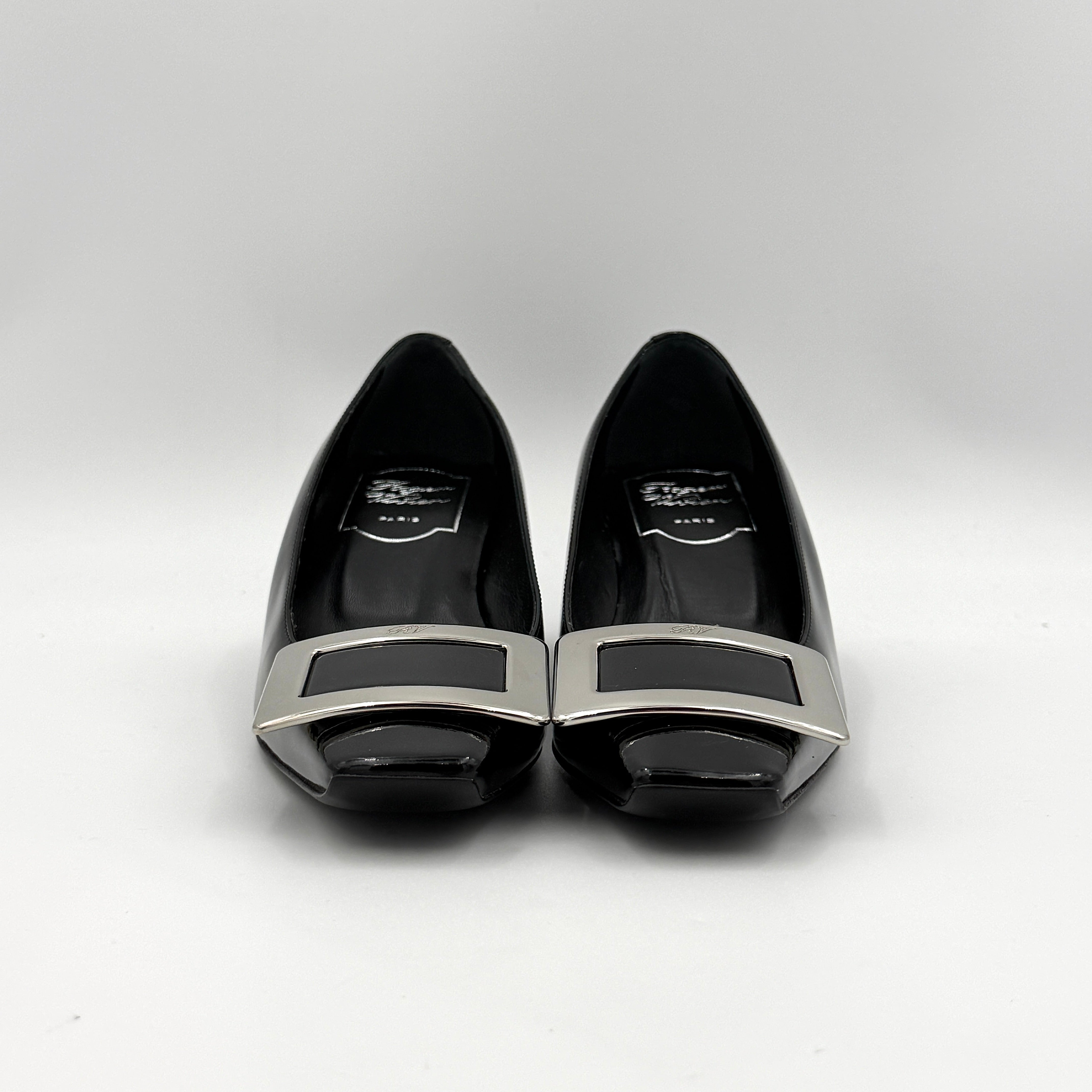 A pair of Roger Vivier Belle Vivier black patent pumps with signature silver-tone buckles, displayed at an angle.