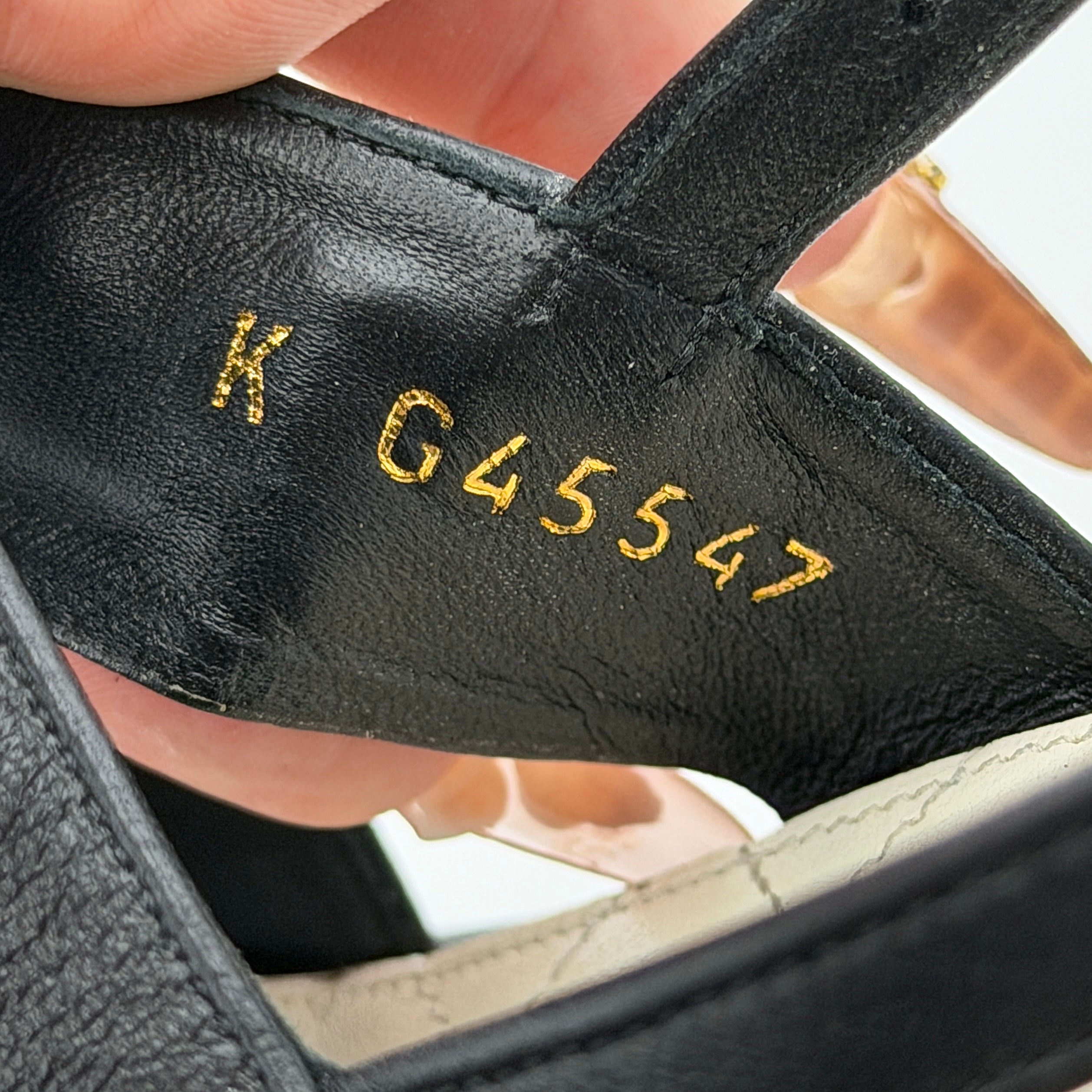 Chanel black quilted leather wedge platform sandals with gold crystal CC hardware and ankle strap detailing.