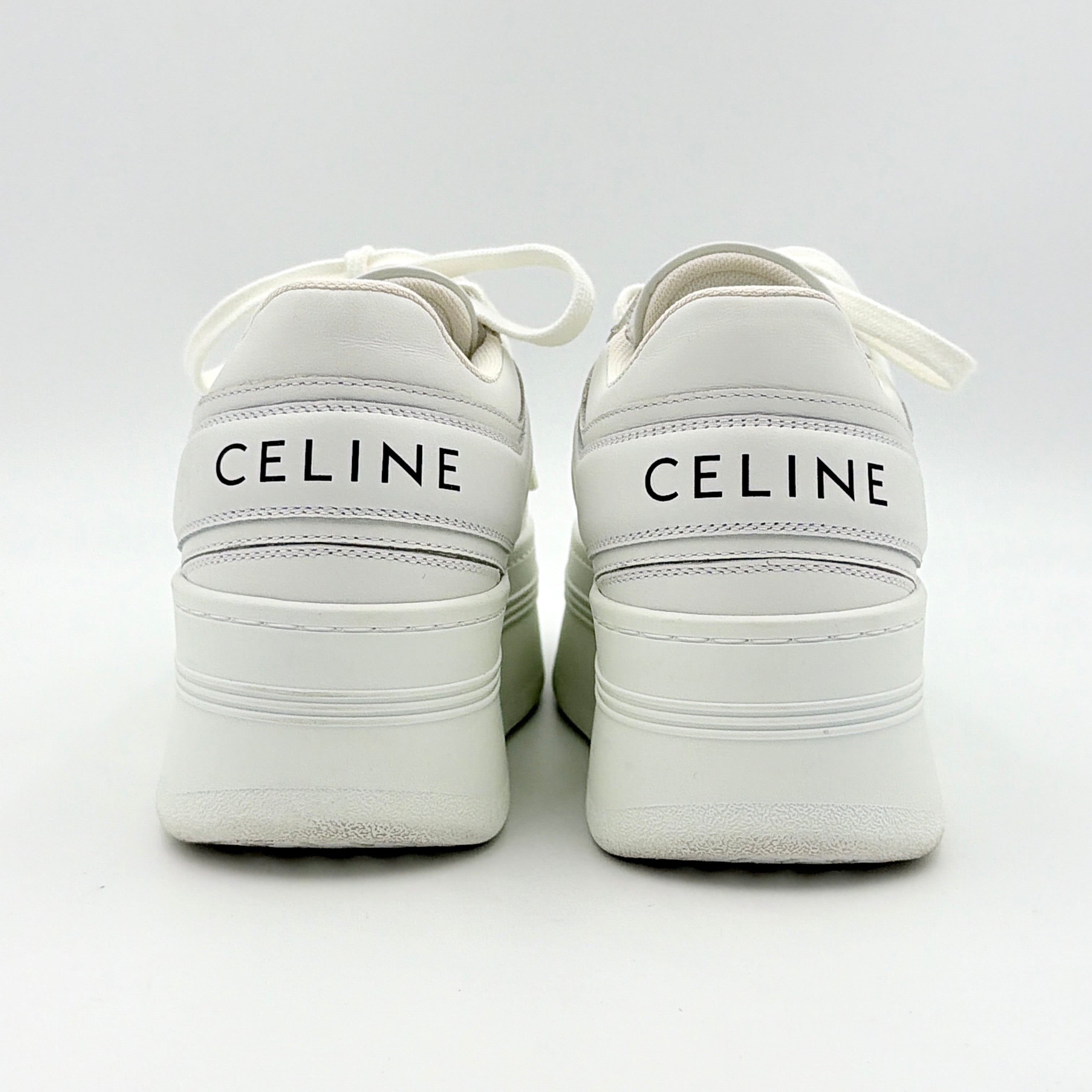 Celine white leather block platform sneakers with bold embossed sole and lace-up front, displayed at a slight angle.