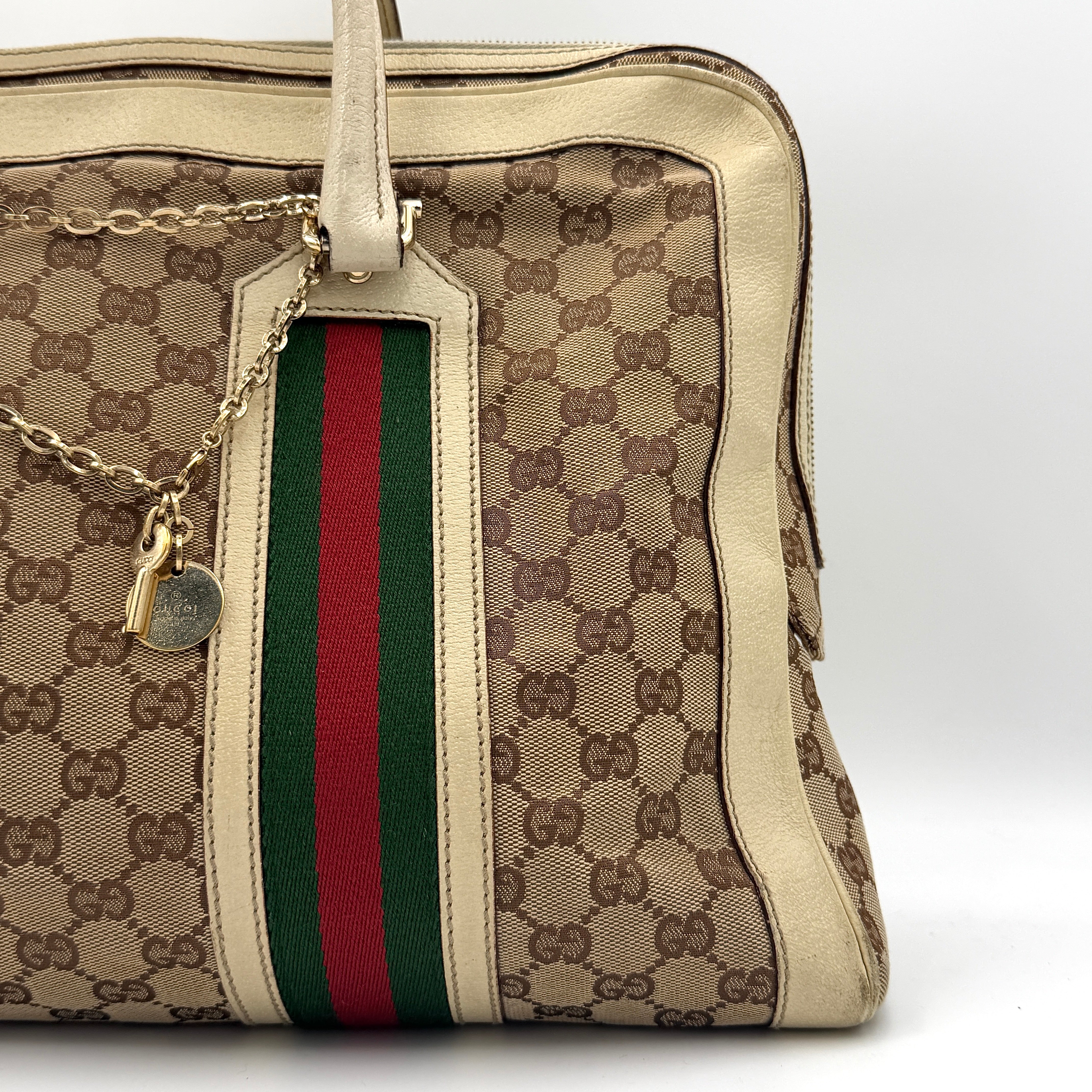 Gucci GG Monogram Stoffa Shoulder Bag in beige canvas with cream leather trim, iconic web stripes, and gold-tone chain detail.