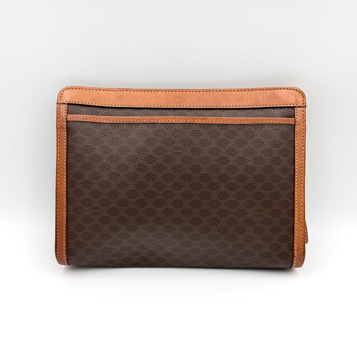 Celine Triomphe Macadam Clutch Bag in brown coated canvas with tan leather trim and gold zip, displayed against a white background.