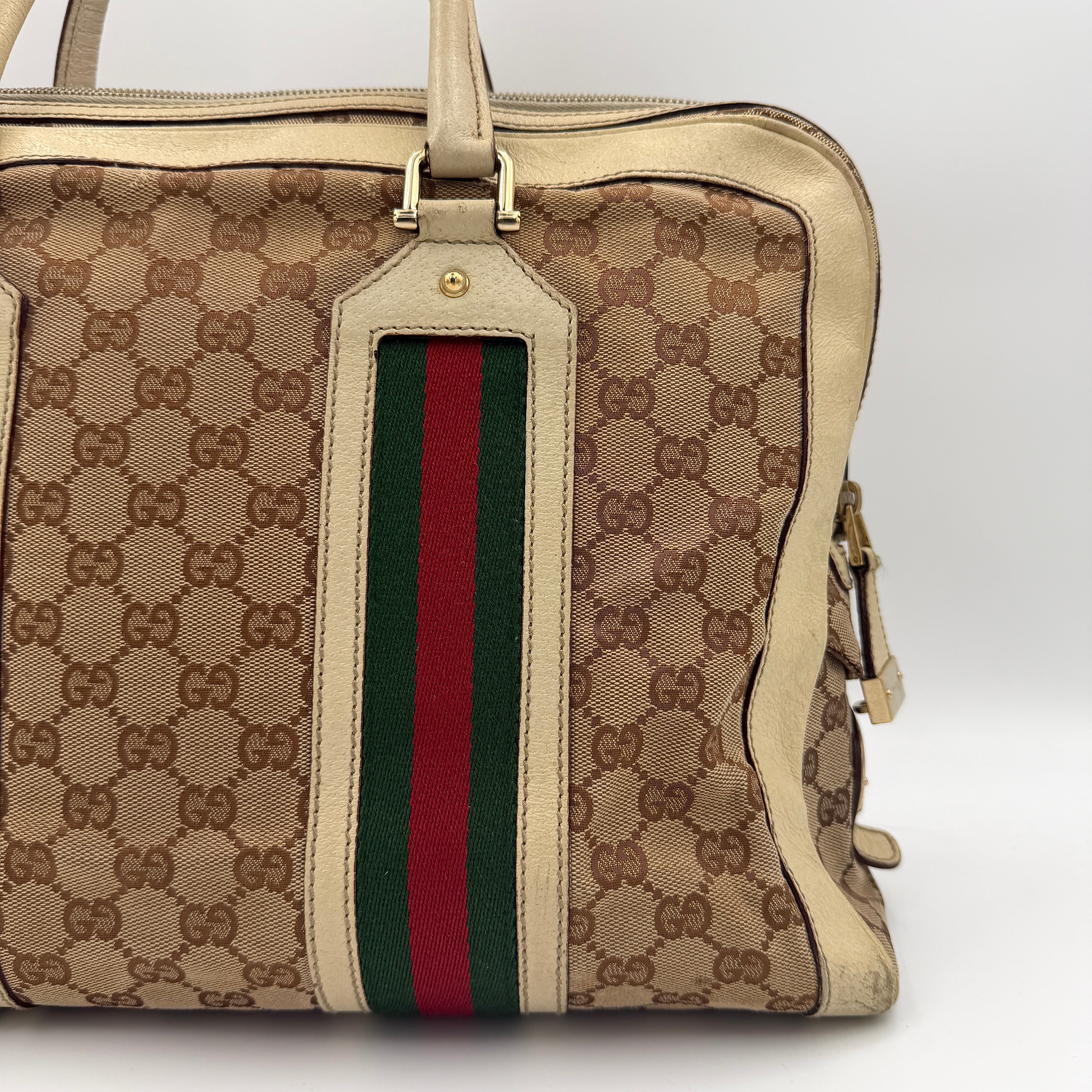 Gucci GG Monogram Stoffa Shoulder Bag in beige canvas with cream leather trim, iconic web stripes, and gold-tone chain detail.