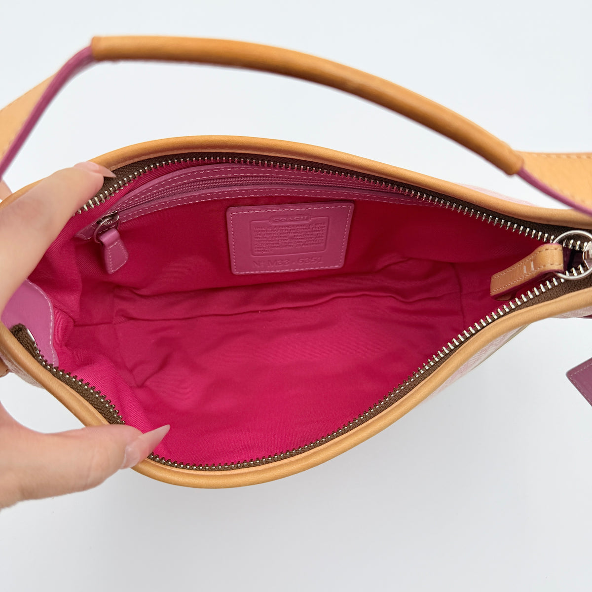 Coach Y2K Signature Hobo Shoulder Bag in pink jacquard with tan and white leather trim, shown on a white background.