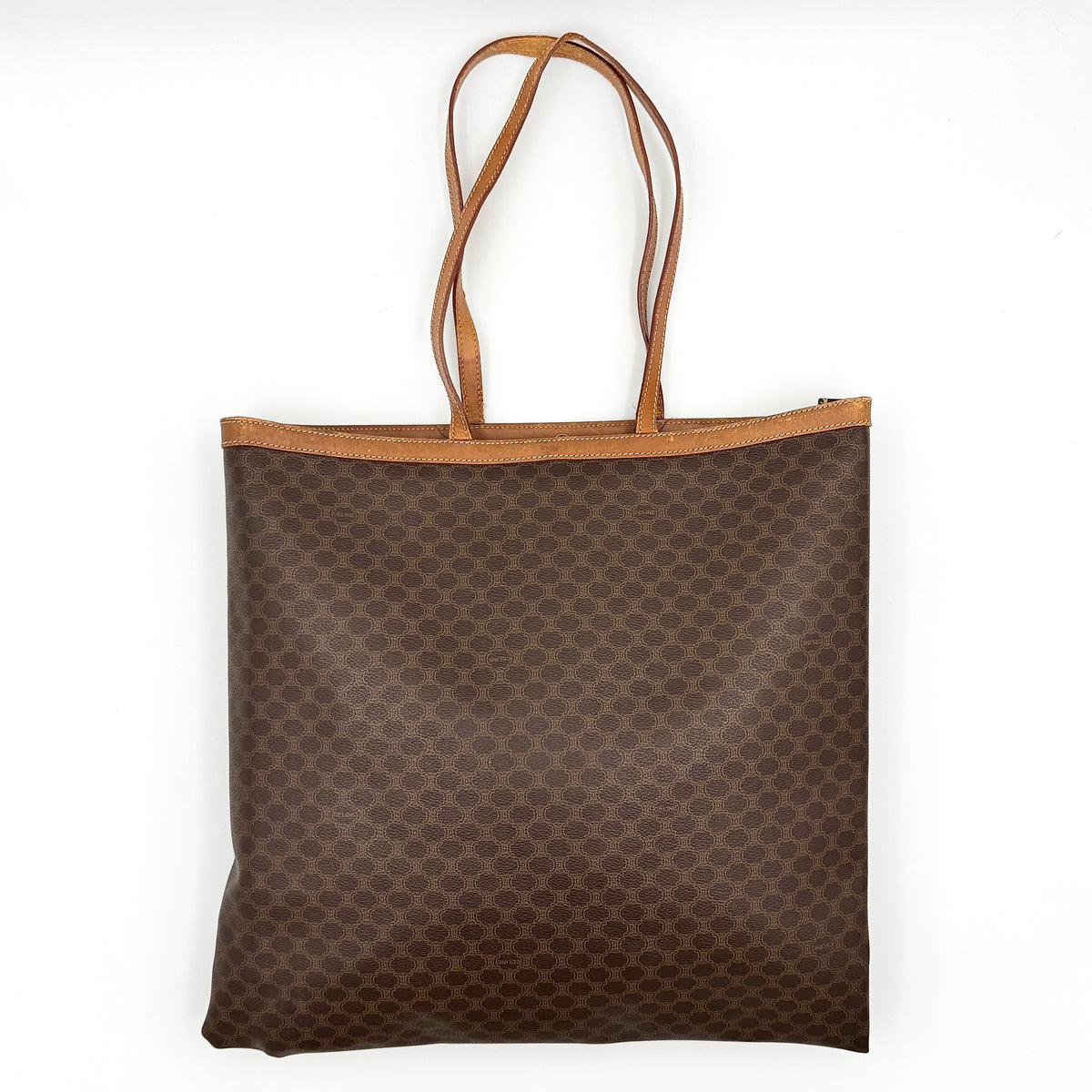 Front view of the Celine Triomphe Macadam Tote Bag in brown coated canvas with tan leather detailing and double handles.