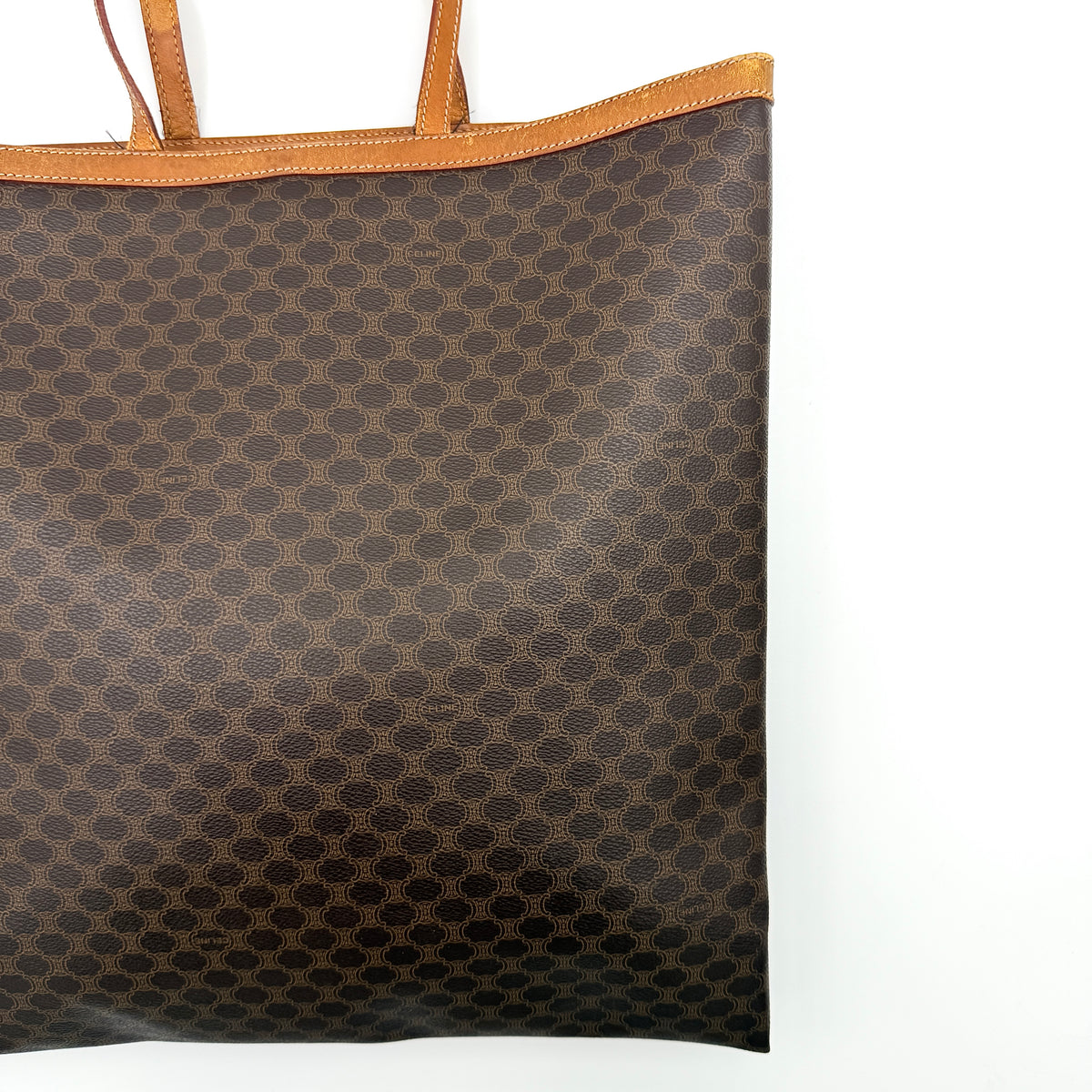 Front view of the Celine Triomphe Macadam Tote Bag in brown coated canvas with tan leather detailing and double handles.